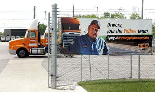 An employment sign hangs Yellow truck terminal May 25, 2005 in Wheeling, Illinois. In a $1.37 billion deal, Overland Park, Kansas-based Yellow Roadway has acquired Chicago-based USF Corporation. Yellow Roadway's workers will now number close to 70,000 with a $9 billion annual revenue.