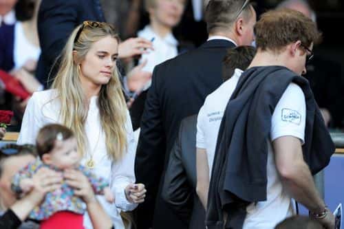 Prince Harry (R) and Cressida Bonas (L) take their seats during the RBS Six Nations match between England and Wales at Twickenham Stadium on March 9, 2014 in London, England.