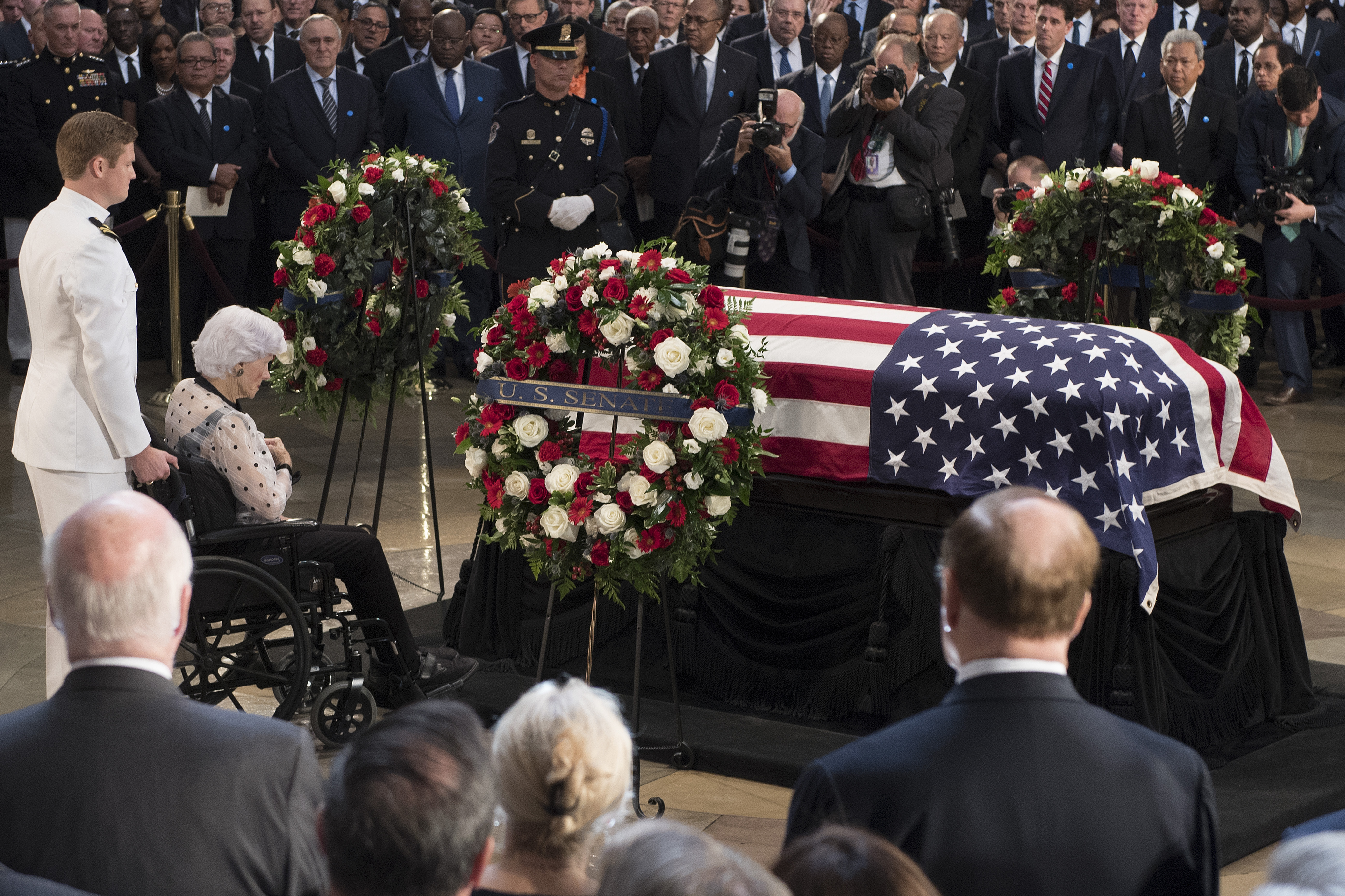 Roberta McCain (2nd L), the 106-year-old mother of John McCain, pays her respects to the flag-draped casket bearing the remains of her son, who lived and worked in Congress over four decades, in the U.S. Capitol rotunda for a farewell ceremony and public visitation, on August 31, 2018 in Washington, DC. The late senator died August 25 at the age of 81 after a long battle with brain cancer. He will lie in state at the U.S. Capitol, a rare honor bestowed on only 31 people in the past 166 years. Sen. McCain will be buried at his final resting place at the U.S. Naval Academy.