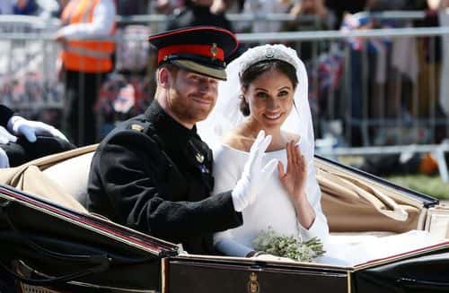 Prince Harry, Duke of Sussex and Meghan, Duchess of Sussex wave from the Ascot Landau Carriage during their carriage procession on Castle Hill outside Windsor Castle in Windsor, on May 19, 2018 after their wedding ceremony. (Photo by Aaron Chown - WPA Pool/Getty Images)