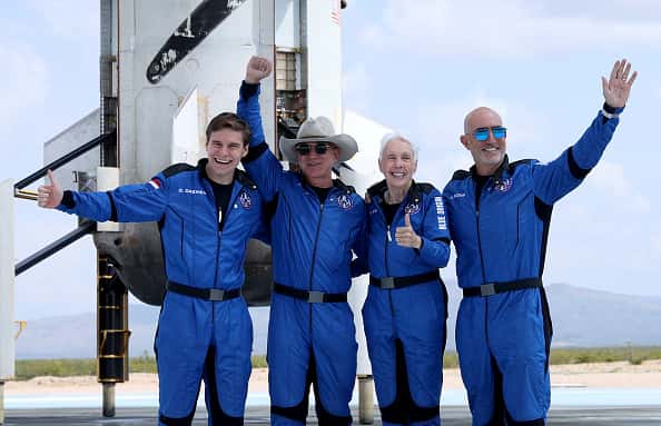 VAN HORN, TEXAS - JULY 20: Blue Origin’s New Shepard crew (L-R) Oliver Daemen, Jeff Bezos, Wally Funk, and Mark Bezos pose for a picture near the booster after flying into space in the Blue Origin New Shepard rocket on July 20, 2021 in Van Horn, Texas. Mr. Bezos and the crew were the first human spaceflight for the company. (Photo by Joe Raedle/Getty Images)