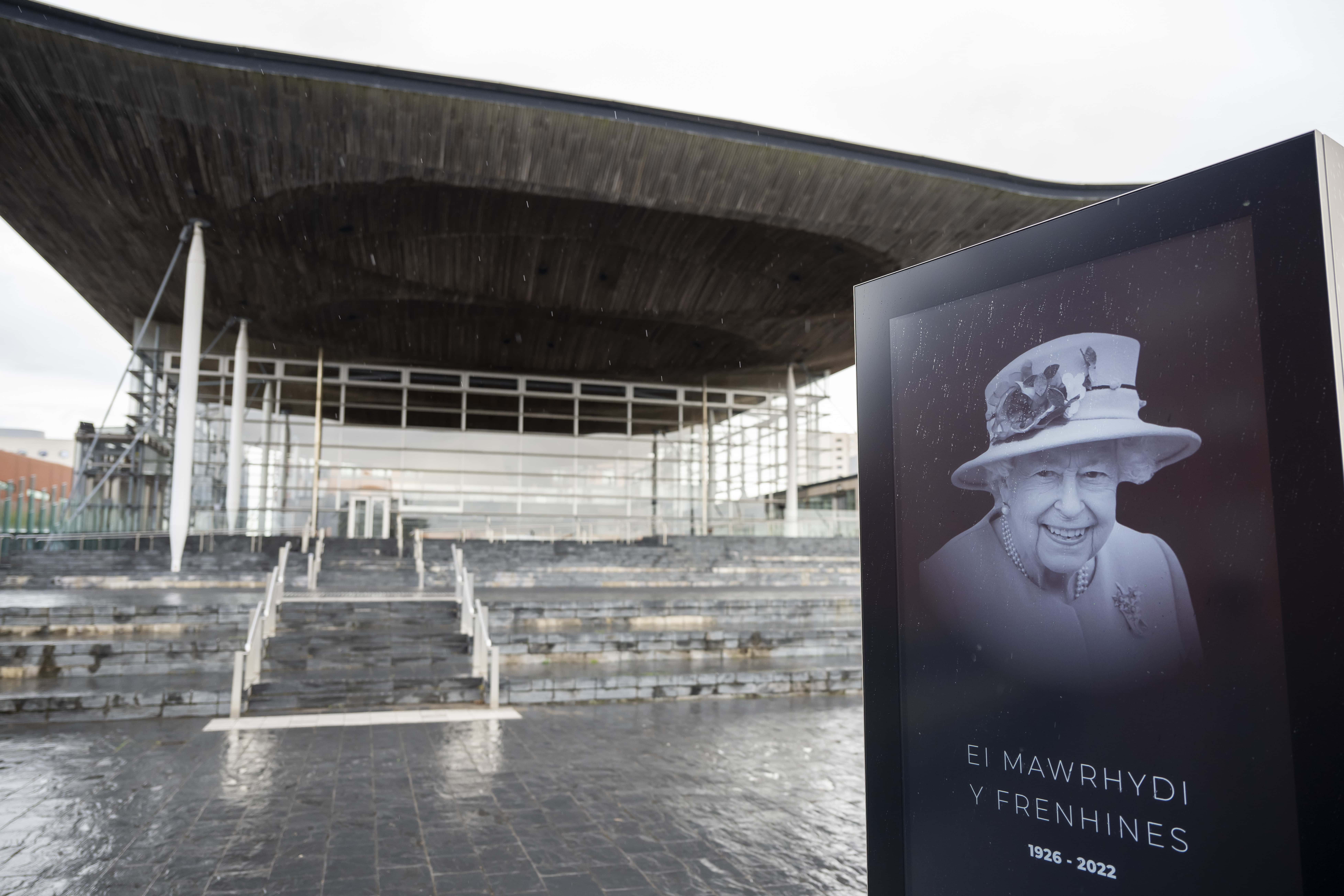 A screen showing a tribute to Queen Elizabeth II in front of the Senedd, home of the Welsh Parliament, on September 9, 2022 in Cardiff, United Kingdom. Elizabeth Alexandra Mary Windsor was born in Bruton Street, Mayfair, London on 21 April 1926. She married Prince Philip in 1947 and acceded the throne of the United Kingdom and Commonwealth on 6 February 1952 after the death of her Father, King George VI. Queen Elizabeth II died at Balmoral Castle in Scotland on September 8, 2022, and is survived by her four children, Charles, Prince of Wales, Anne, Princess Royal, Andrew, Duke Of York and Edward, Duke of Wessex. (Photo by Matthew Horwood/Getty Images)