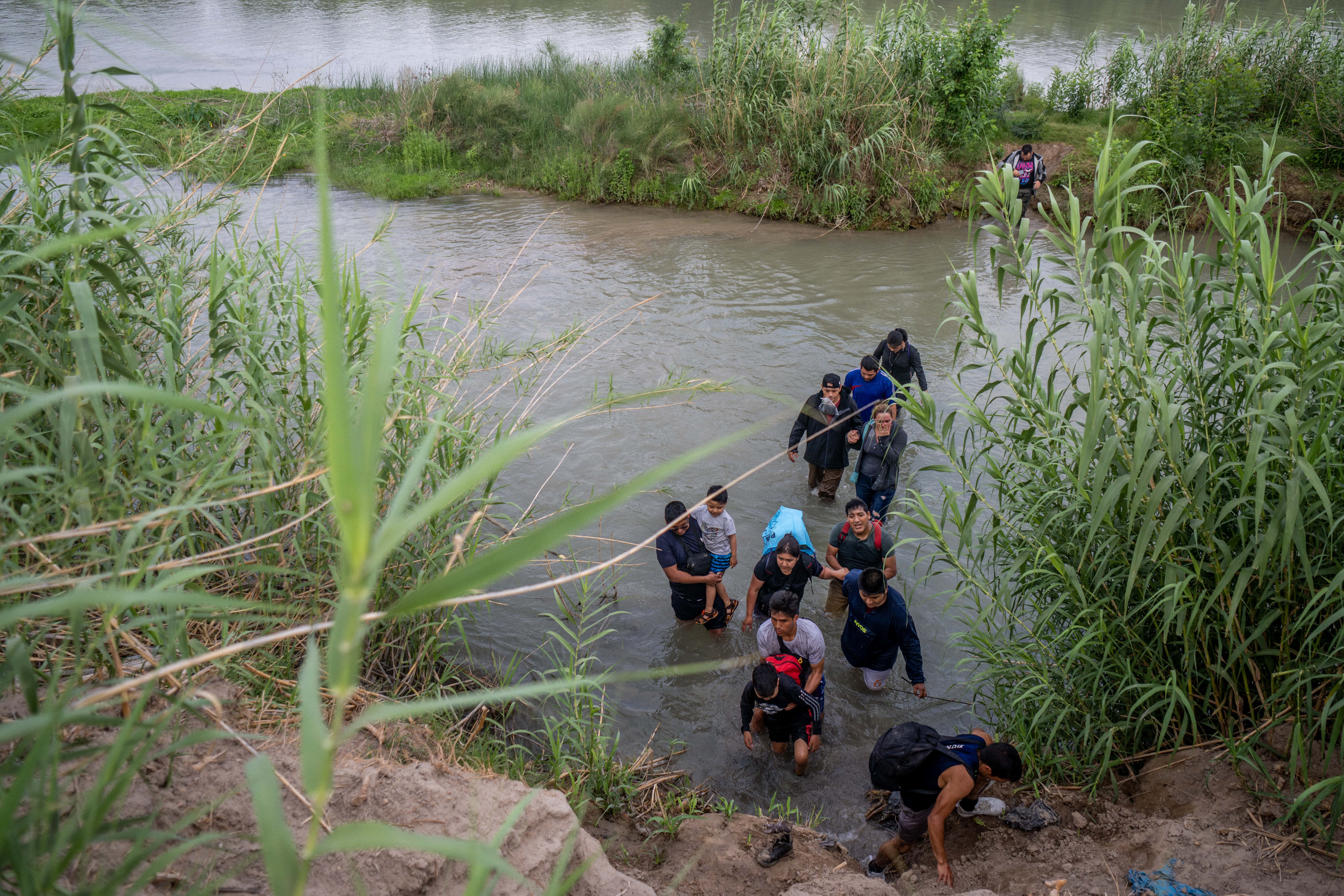 Migrants from Peru cross the Rio Grande into the U.S. on May 21, 2022 in Eagle Pass, Texas. Title 42, the controversial pandemic-era border policy enacted by former President Trump, which cites COVID-19 as the reason to rapidly expel asylum seekers at the U.S. border, was set to officially expire on May 23rd. A federal judge in Louisiana delivered a ruling today blocking the Biden administration from lifting Title 42.