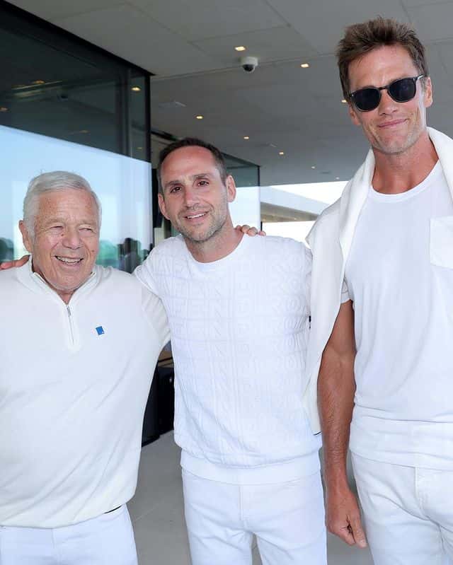 Tom Btrady at the Michael Rubin's all white party with Michael Rubin posing with the NFL player in the middle (michaelrubin/Instagram)