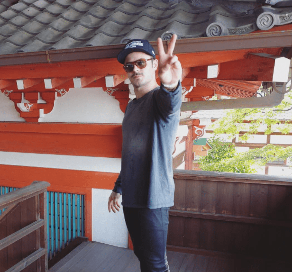 Zac Efron flaunts a hint of facial scruff as he explores Tokyo. 