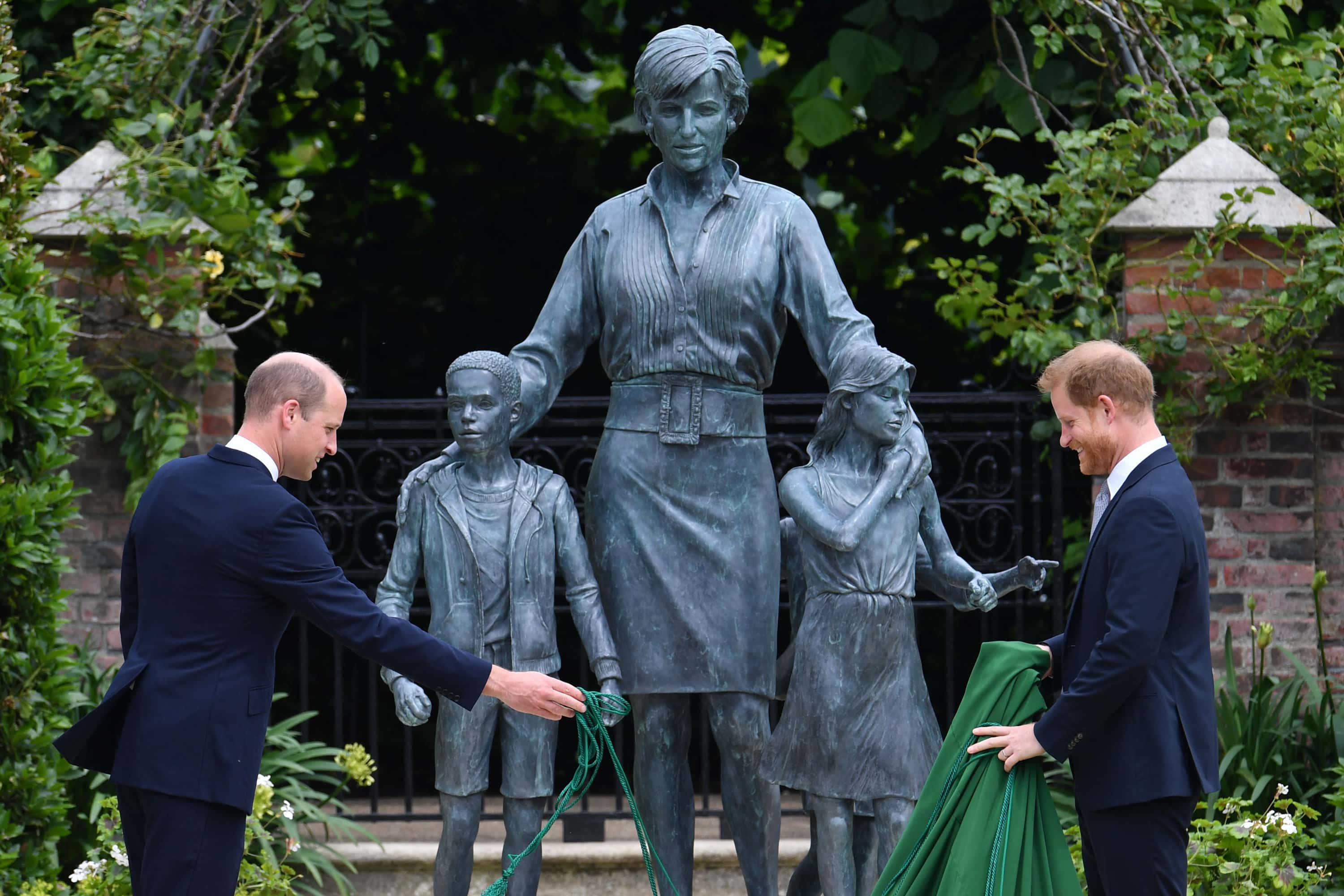 Prince William, Duke of Cambridge (left) and Prince Harry, Duke of Sussex unveil a statue they commissioned of their mother Diana, Princess of Wales, in the Sunken Garden at Kensington Palace, on what would have been her 60th birthday on July 1, 2021 in London, England. Today would have been the 60th birthday of Princess Diana, who died in 1997. At a ceremony here today, her sons Prince William and Prince Harry, the Duke of Cambridge and the Duke of Sussex respectively, will unveil a statue in her memory. (Photo by Dominic Lipinski - WPA Pool/Getty Images)