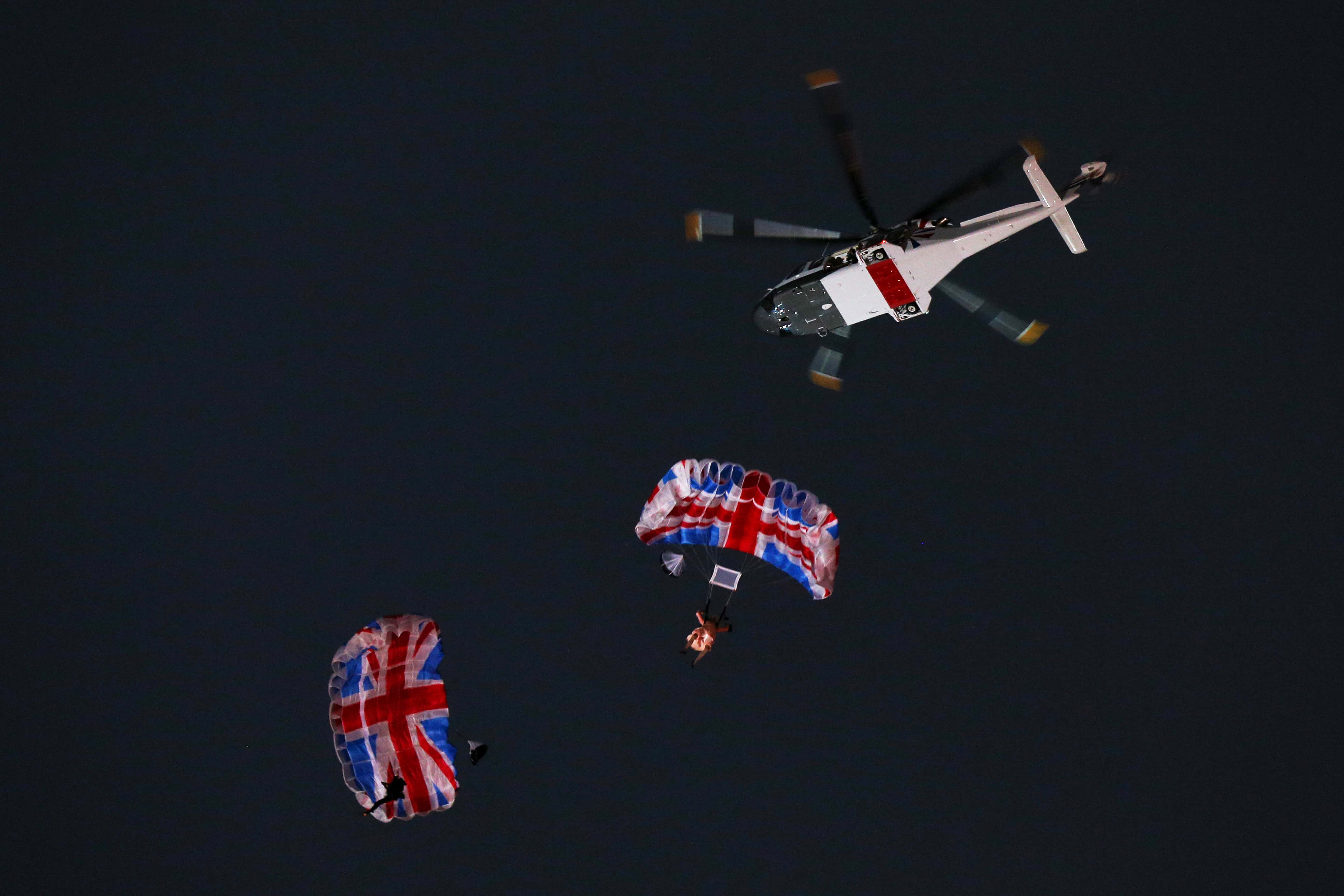 Gary Connery and Mark Sutton parachute into the stadium as part of short James Bond film featuring Daniel Craig and The Queen during the Opening Ceremony of the London 2012 Olympic Games at the Olympic Stadium on July 27, 2012 in London, England.