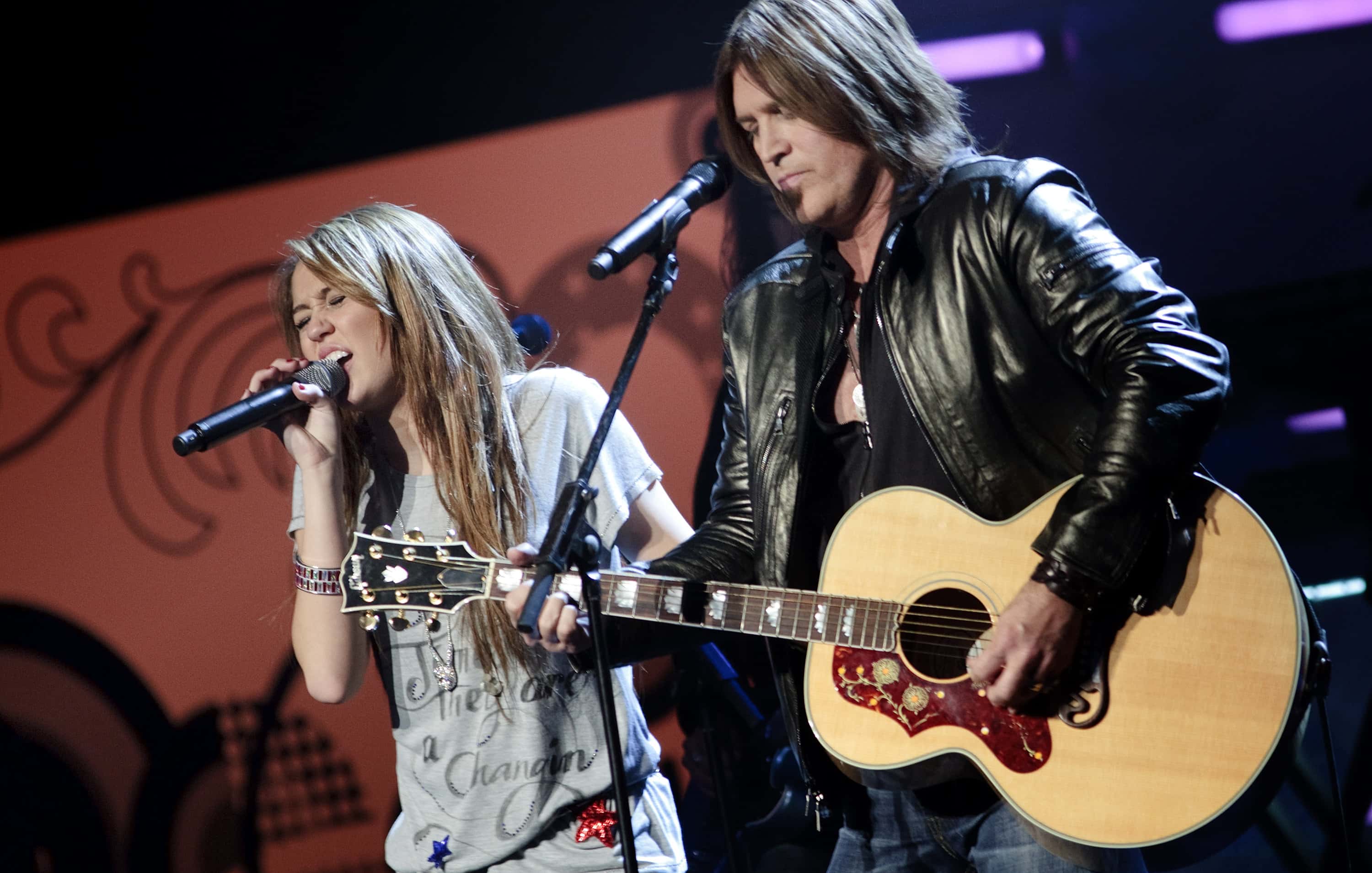 Miley Cyrus performs with her father Billy Ray Cyrus during the We Are The Future kids Ball January 19, 2009 in Washington, DC.  President Elect Barack Obama will be sworn in as the 44th President of the United States tomorrow.