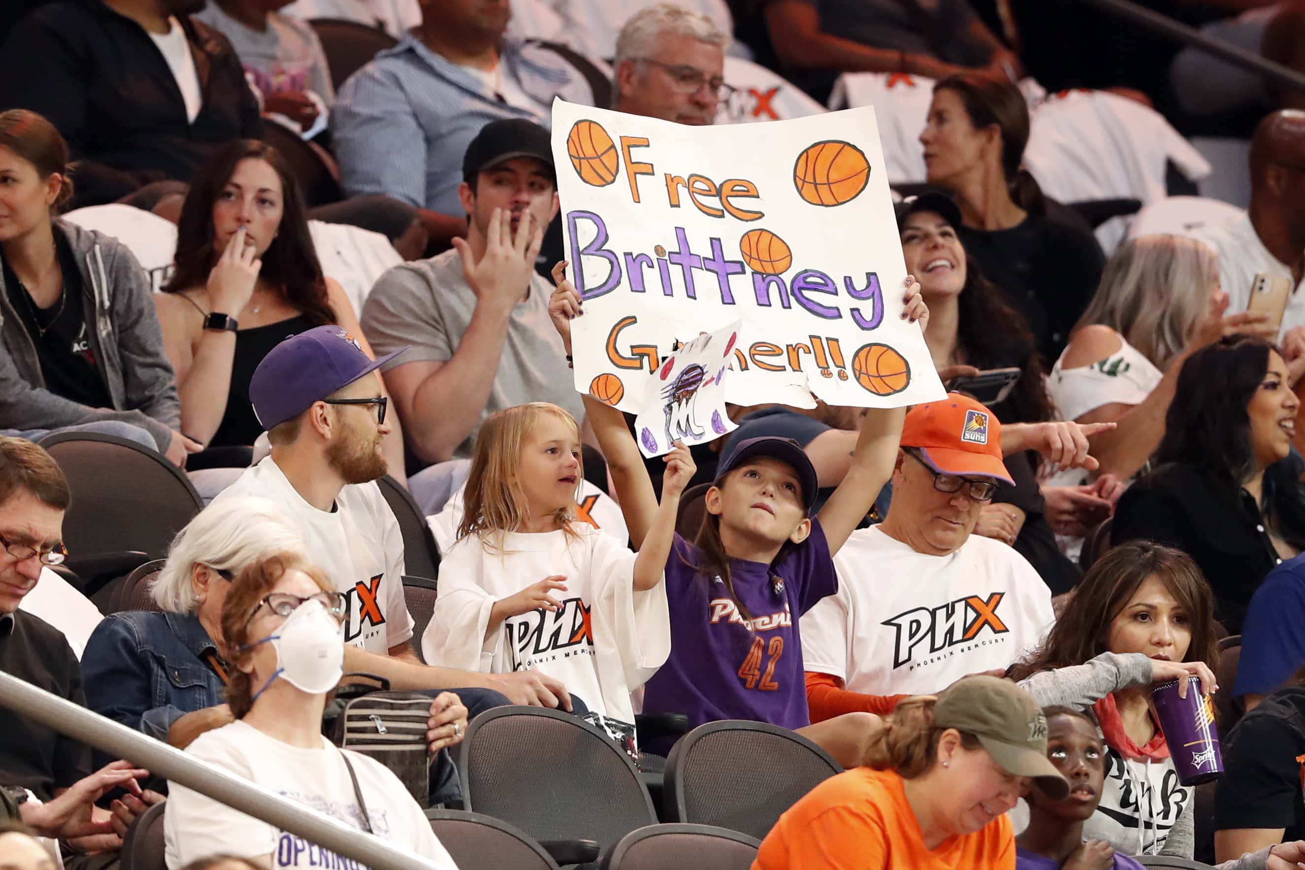 A young fan holds a sign honoring Brittney Griner during the game between the Phoenix Mercury and the Las Vegas Aces at Footprint Center on May 06, 2022 in Phoenix, Arizona. Phoenix Mercury center Brittney Griner has been detained by the Russian government since February. NOTE TO USER: User expressly acknowledges and agrees that, by downloading and or using this photograph, User is consenting to the terms and conditions of the Getty Images License Agreement. (Photo by Chris Coduto/Getty Images)