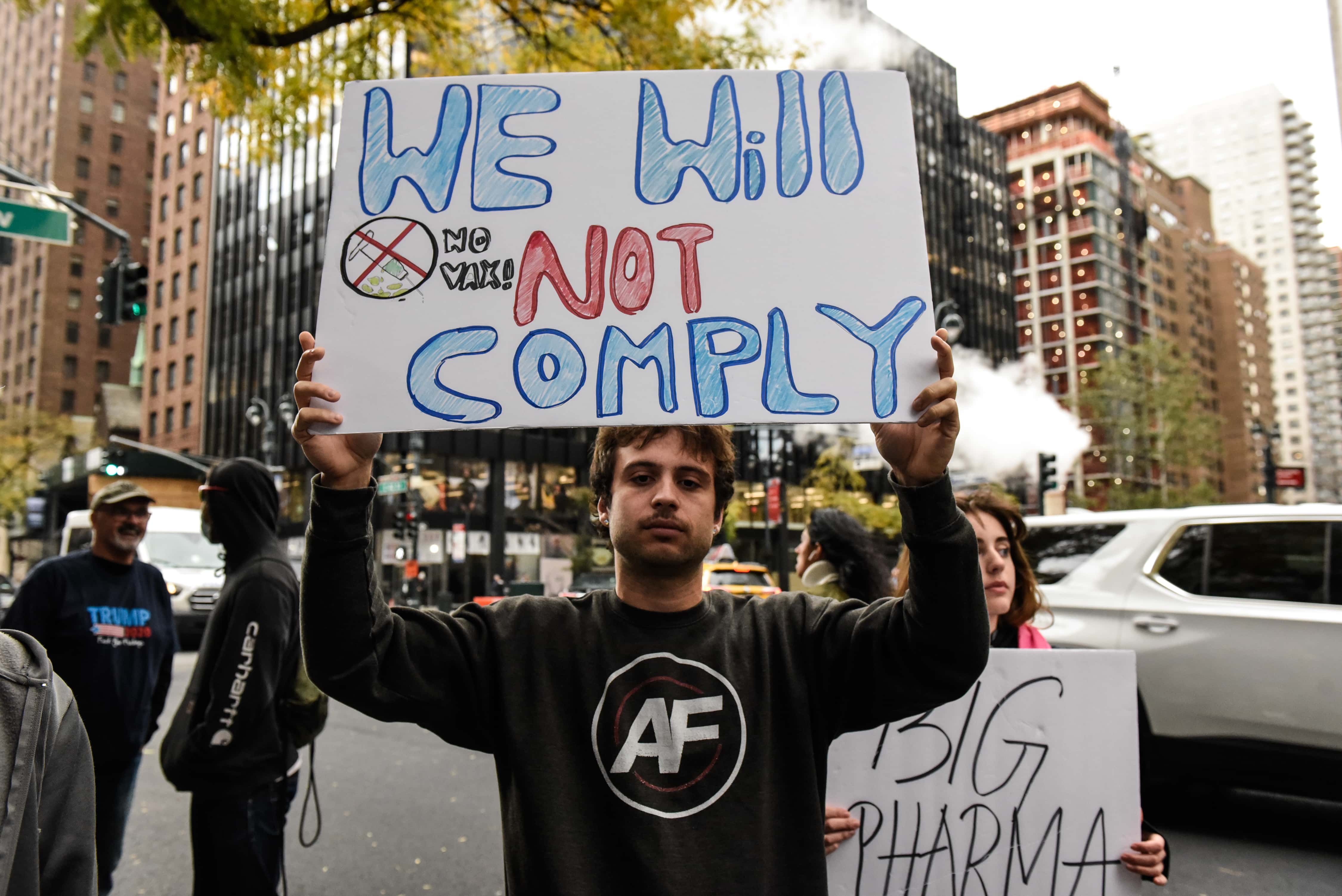 People associated with the far-right group America First attend an anti-vaccine protest in front of Pfizer world headquarters on November 13, 2021 in New York City. A U.S. Circuit Court granted an emergency stay to temporarily stop the Biden administration's vaccine requirement for businesses with 100 or more workers as many feel it is an unlawful overreach.