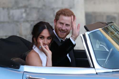 Prince Harry, Duke of Sussex and Meghan, Duchess of Sussex wave as they leave Windsor Castle after their wedding to attend an evening reception at Frogmore House, hosted by the Prince of Wales on May 19, 2018 in Windsor, England.