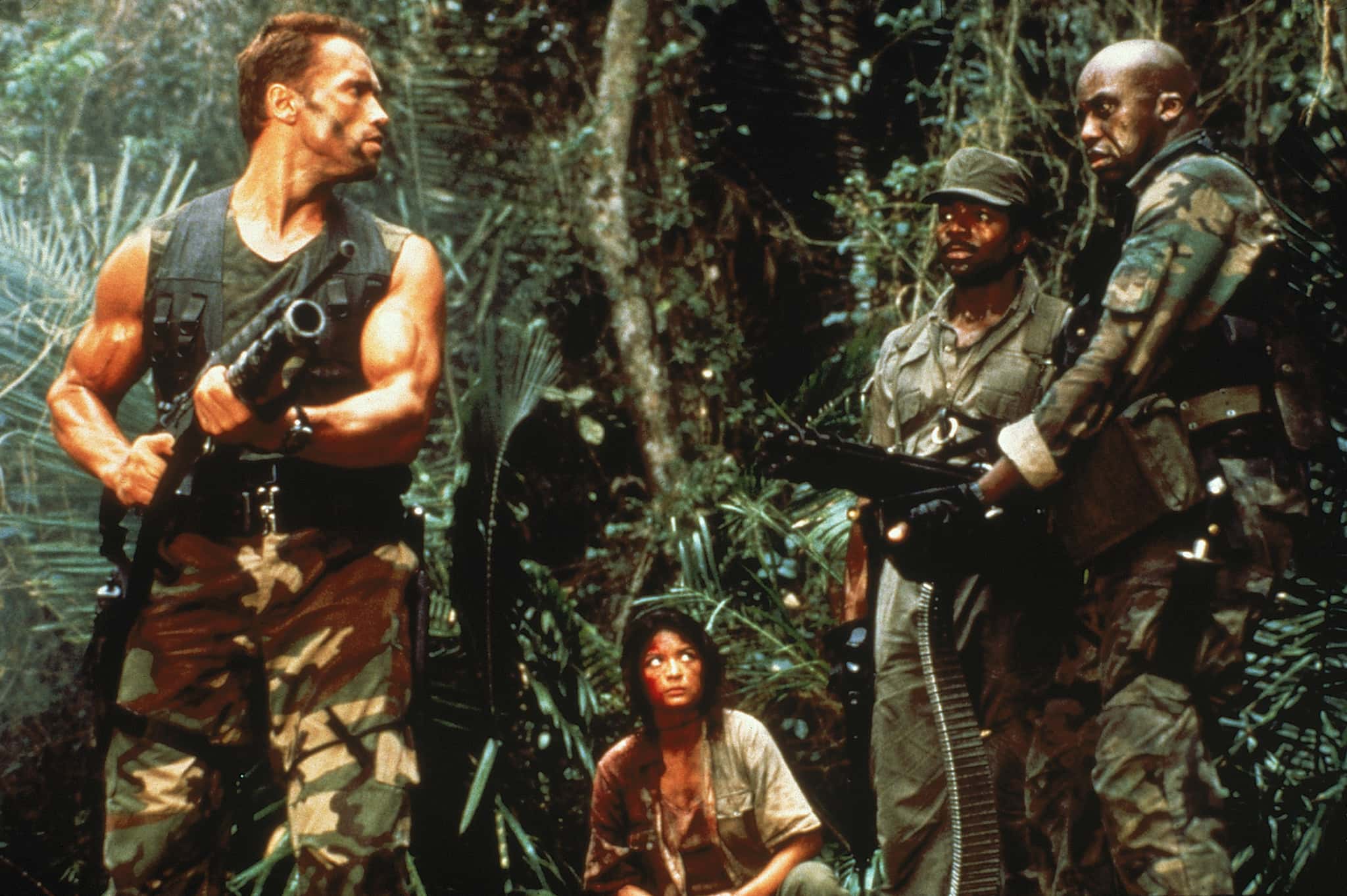 Arnold Schwarzenegger (Dutch), Elpidia Carrillo (Anna), Carl Weathers (Dillon) and Bill Duke (Mac) in 'Predator' (20th Century Studios)
