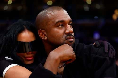Rapper Kanye West and girlfriend Chaney Jones attend a game between the Washington Wizards and the Los Angeles Lakers in the fourth quarter at Crypto.com Arena on March 11, 2022 in Los Angeles, California.  NOTE TO USER: User expressly acknowledges and agrees that, by downloading and/or using this Photograph, user is consenting to the terms and conditions of the Getty Images License Agreement.
