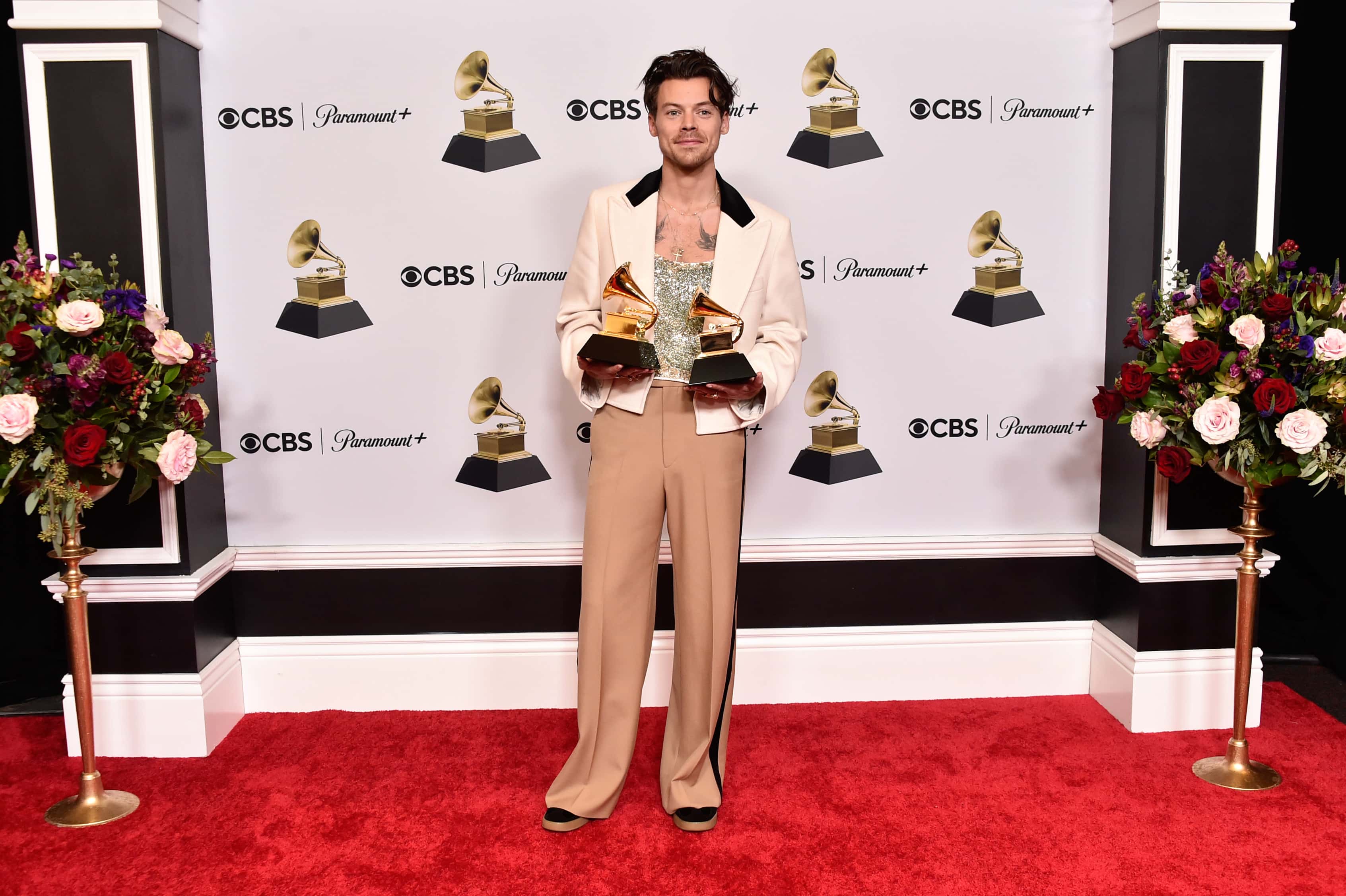 Harry Styles poses with the Best Pop Vocal Album Award for “Harry’s House” and Album of the Year Award for “Harry’s House” in the press room during the 65th GRAMMY Awards at Crypto.com Arena on February 05, 2023, in Los Angeles, California. (Photo by Alberto E. Rodriguez/Getty Images for The Recording Academy)