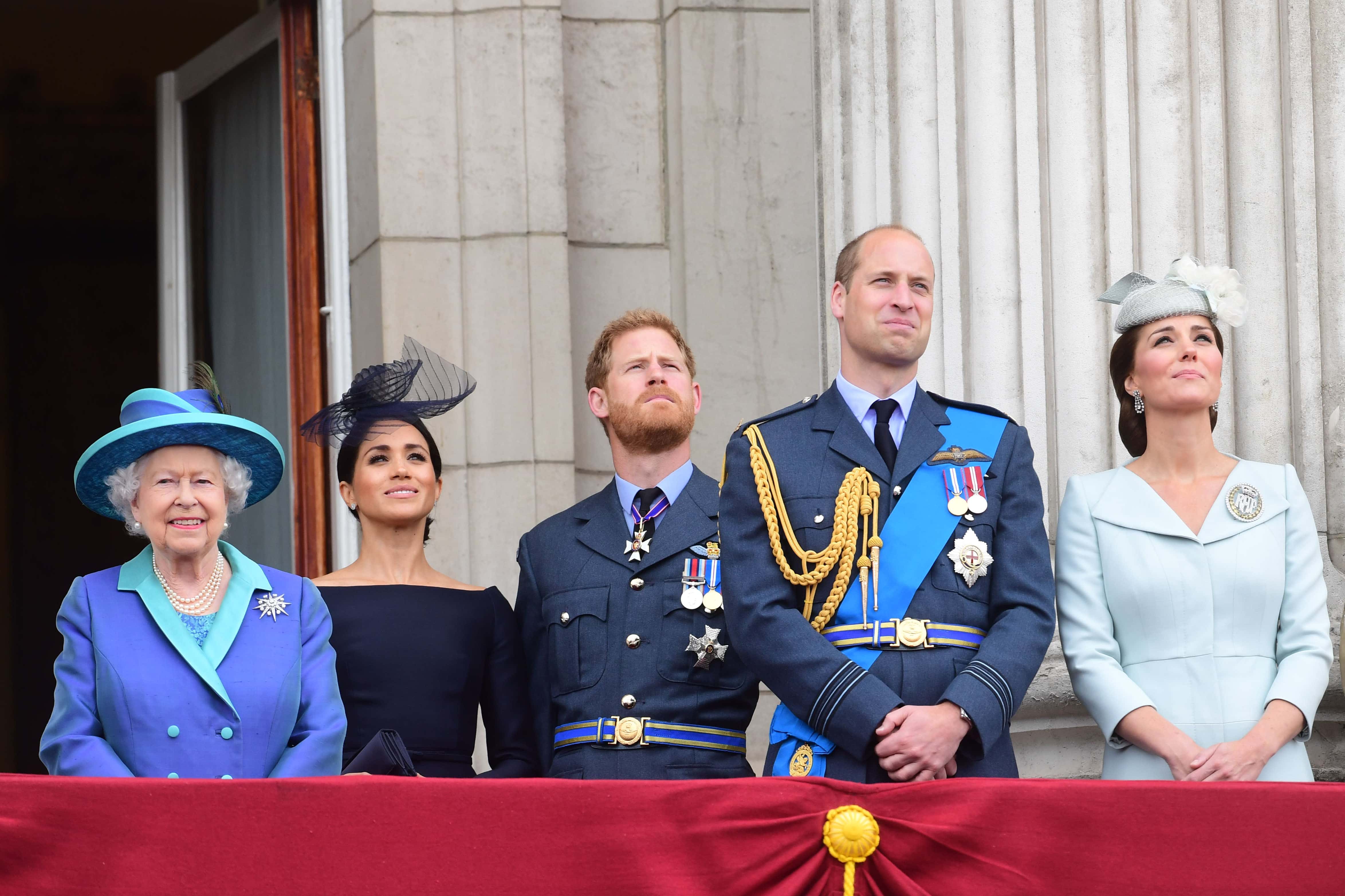 Queen Elizabeth II, Meghan, Duchess of Sussex, Prince Harry, Duke of Sussex, Prince William Duke of Cambridge and Catherine, Duchess of Cambridge watch the RAF 100th anniversary flypast from the balcony of Buckingham Palace on July 10, 2018 in London, England.