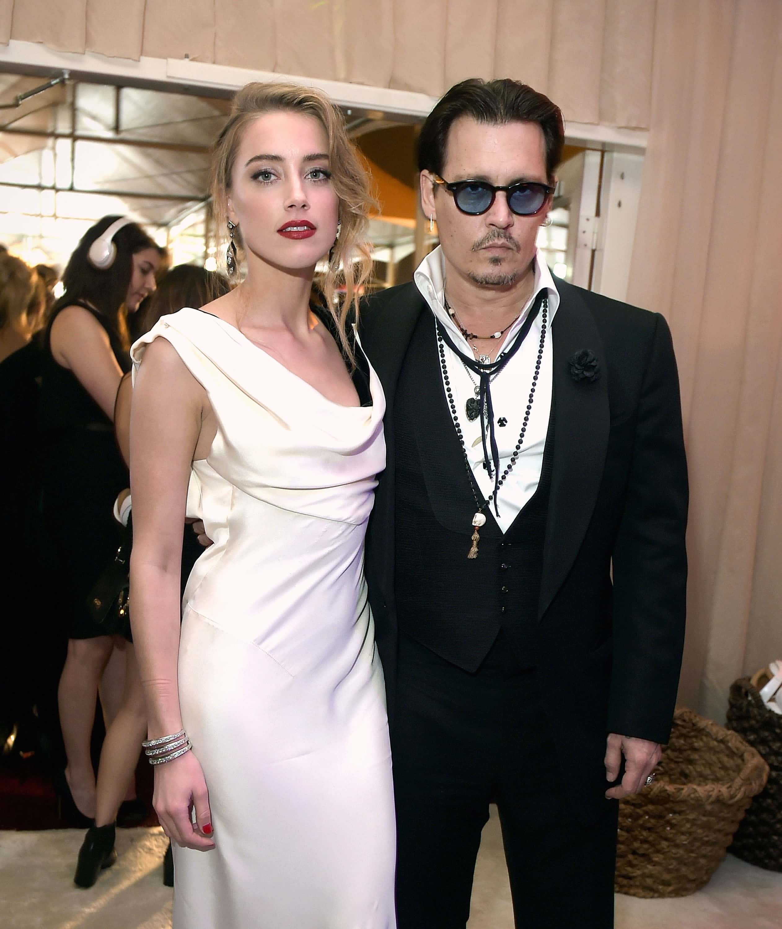 Actors Amber Heard (L) and Johnny Depp attend the 8th Annual HEAVEN Gala presented by Art of Elysium and Samsung Galaxy at Hangar 8 on January 10, 2015 in Los Angeles, California. (Photo by Jason Kempin/Getty Images)