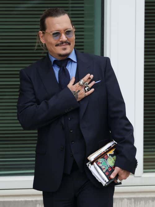 Actor Johnny Depp takes a break during his trial at a Fairfax County Courthouse on May 27, 2022 in Fairfax, Virginia. Closing arguments in the Depp v. Heard defamation trial, brought by Johnny Depp against his ex-wife Amber Heard, begins today.
