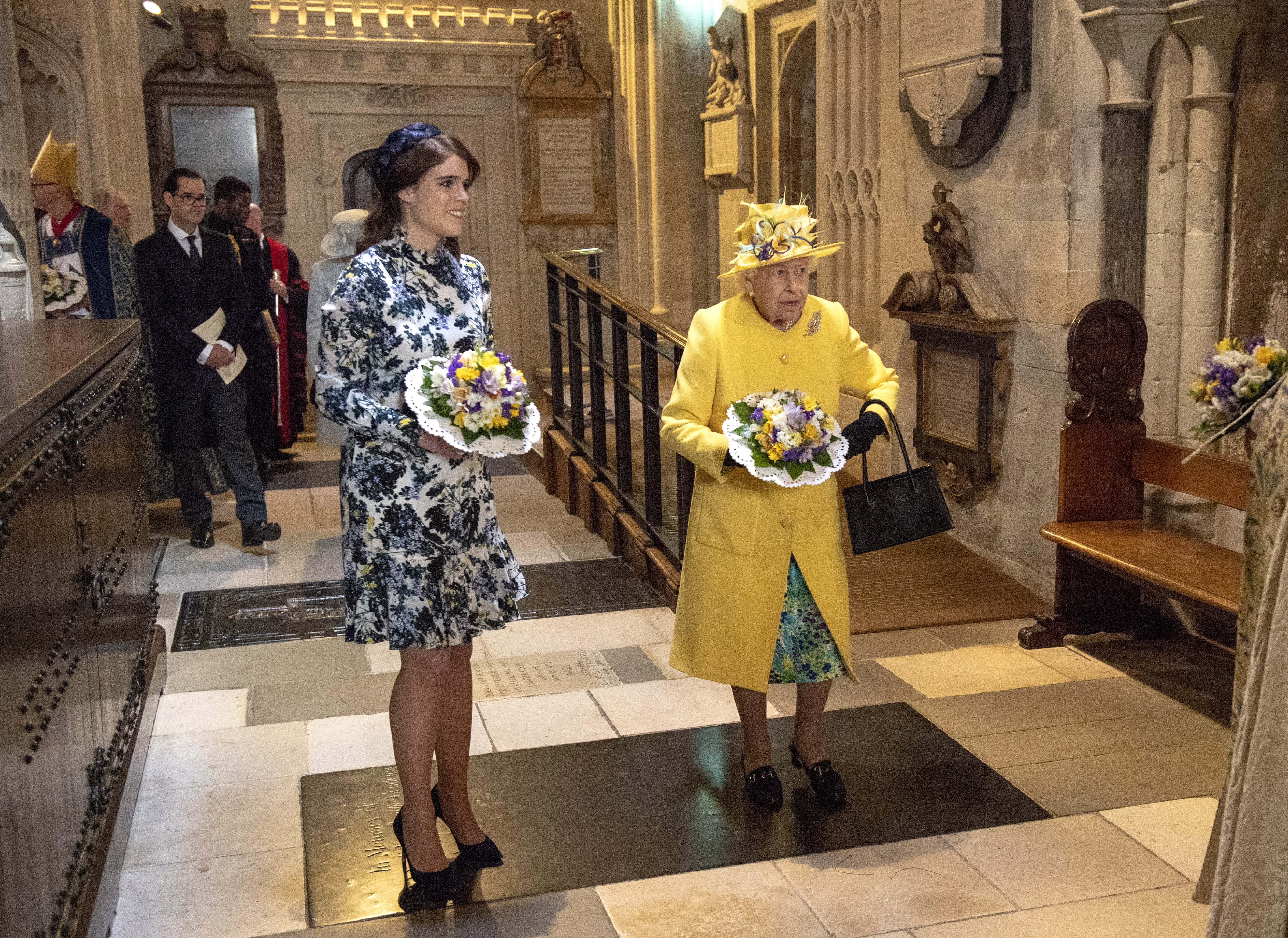 Queen Elizabeth II and Princess Eugenie of York hold nosegays as they attend the traditional Royal Maundy Service at St George's Chapel on April 18, 2019 in Windsor, England.