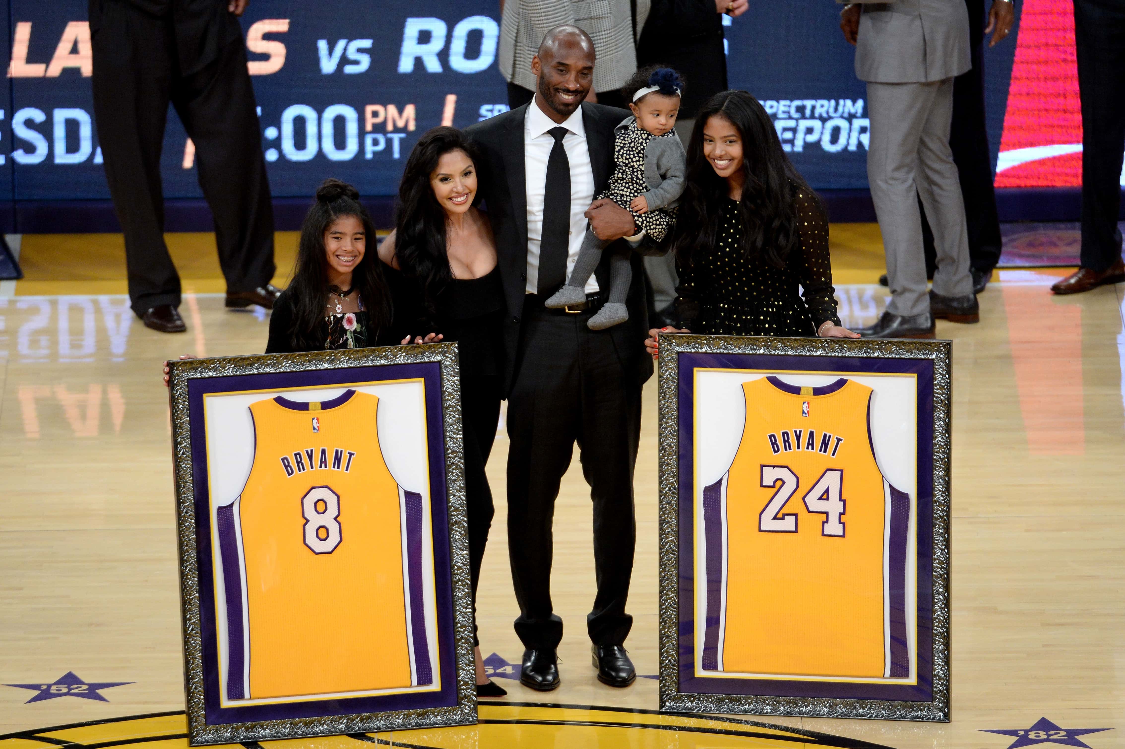 Kobe Bryant poses with his family at halftime after both his #8 and #24 Los Angeles Lakers jerseys are retired at Staples Center on December 18, 2017 in Los Angeles, California. NOTE TO USER: User expressly acknowledges and agrees that, by downloading and or using this photograph, User is consenting to the terms and conditions of the Getty Images License Agreement.