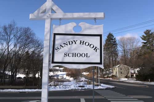 A sign stands near the site of the December 2012 Sandy Hook school shooting on the day of the National School Walkout on March 14, 2018 in Sandy Hook Connecticut. Several hundred students at the school, near the site of the Sandy Hook school massacre of December 14, 2012, staged a protest one month after 17 people were killed at Stoneman Douglas High School in Parkland, Florida. Media and visitors were not allowed on the Newtown High campus for the event.