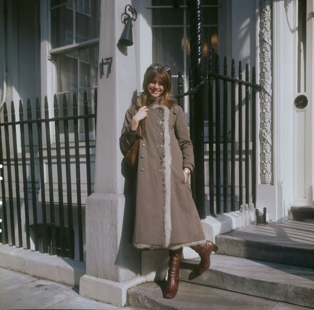 English-Australian singer, Olivia Newton-John, wearing a three-quarter length coat and boots, London, circa 1970. (Photo by Keystone/Hulton Archive/Getty Images)