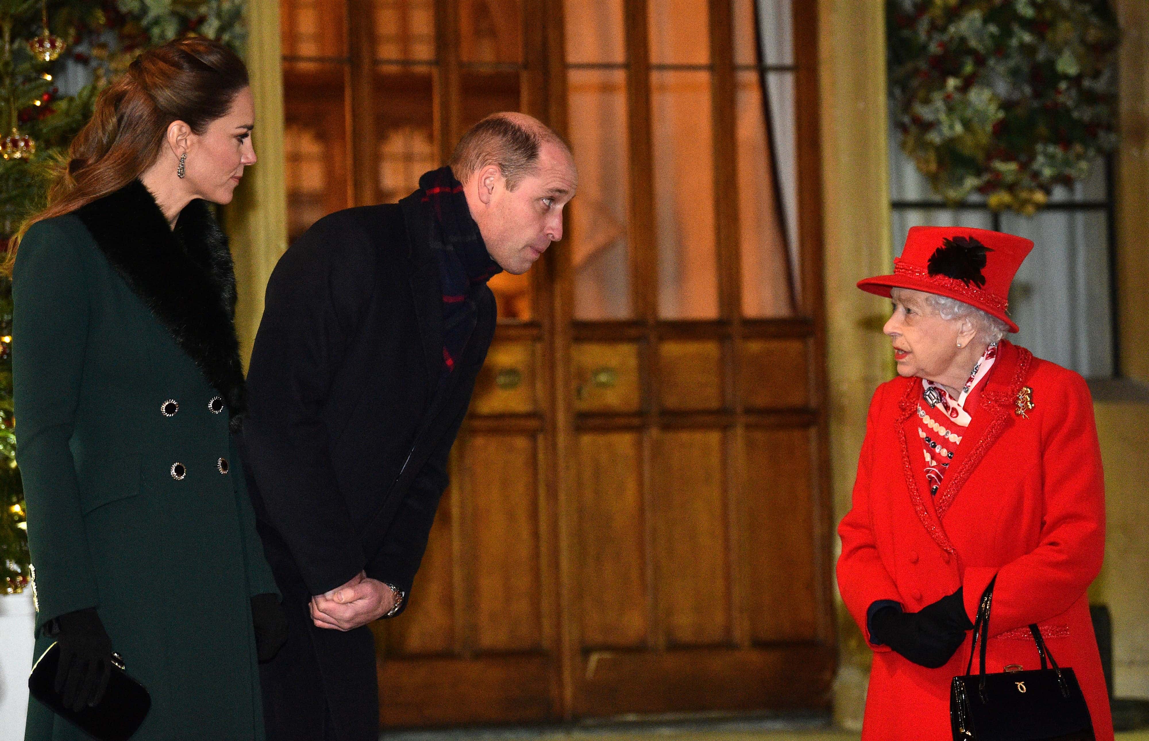 Queen Elizabeth II (R) talks with Prince William, Duke of Cambridge, (2L) and Catherine, Duchess of Cambridge, as they wait to thank local volunteers and key workers for the work they are doing during the coronavirus pandemic and over Christmas in the quadrangle of Windsor Castle on December 8, 2020 in Windsor, England.  The Queen and members of the royal family gave thanks to local volunteers and key workers for their work in helping others during the coronavirus pandemic and over Christmas at Windsor Castle in what was also the final stop for the Duke and Duchess of Cambridge on their tour of England, Wales and Scotland.