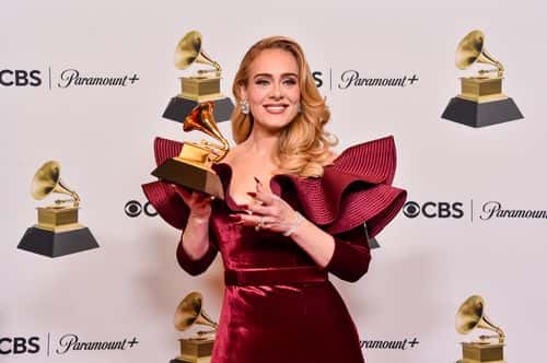 Adele poses with the Best Pop Solo Performance Award for 