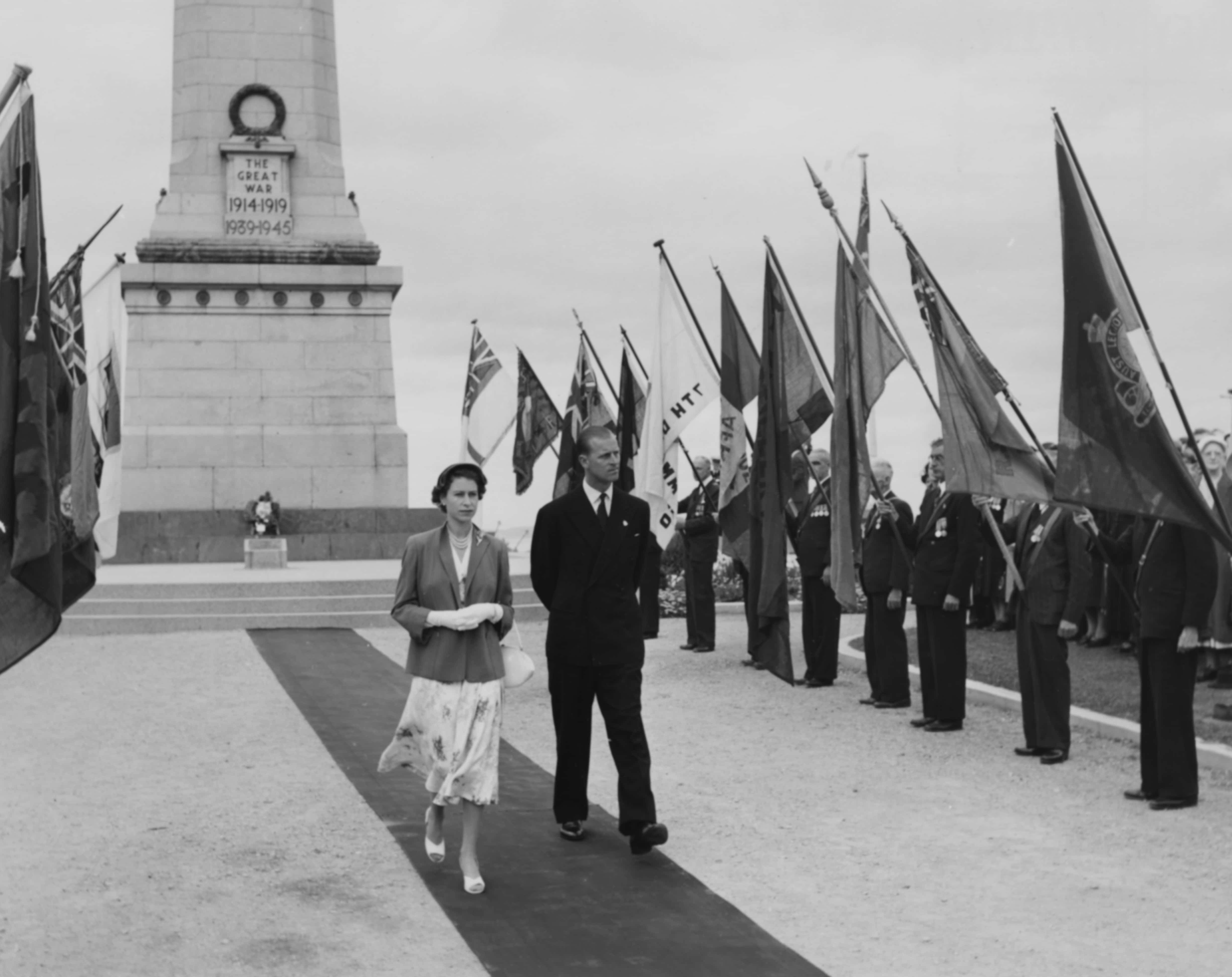 Queen Elizabeth II and the Duke of Edinburgh walking past the standards of the ex-servicemen's associations after laying a wreath on the war memorial, at Queen's Domain, Hobart, February 21st 1954. (Photo by Hulton Archive/Getty Images)
