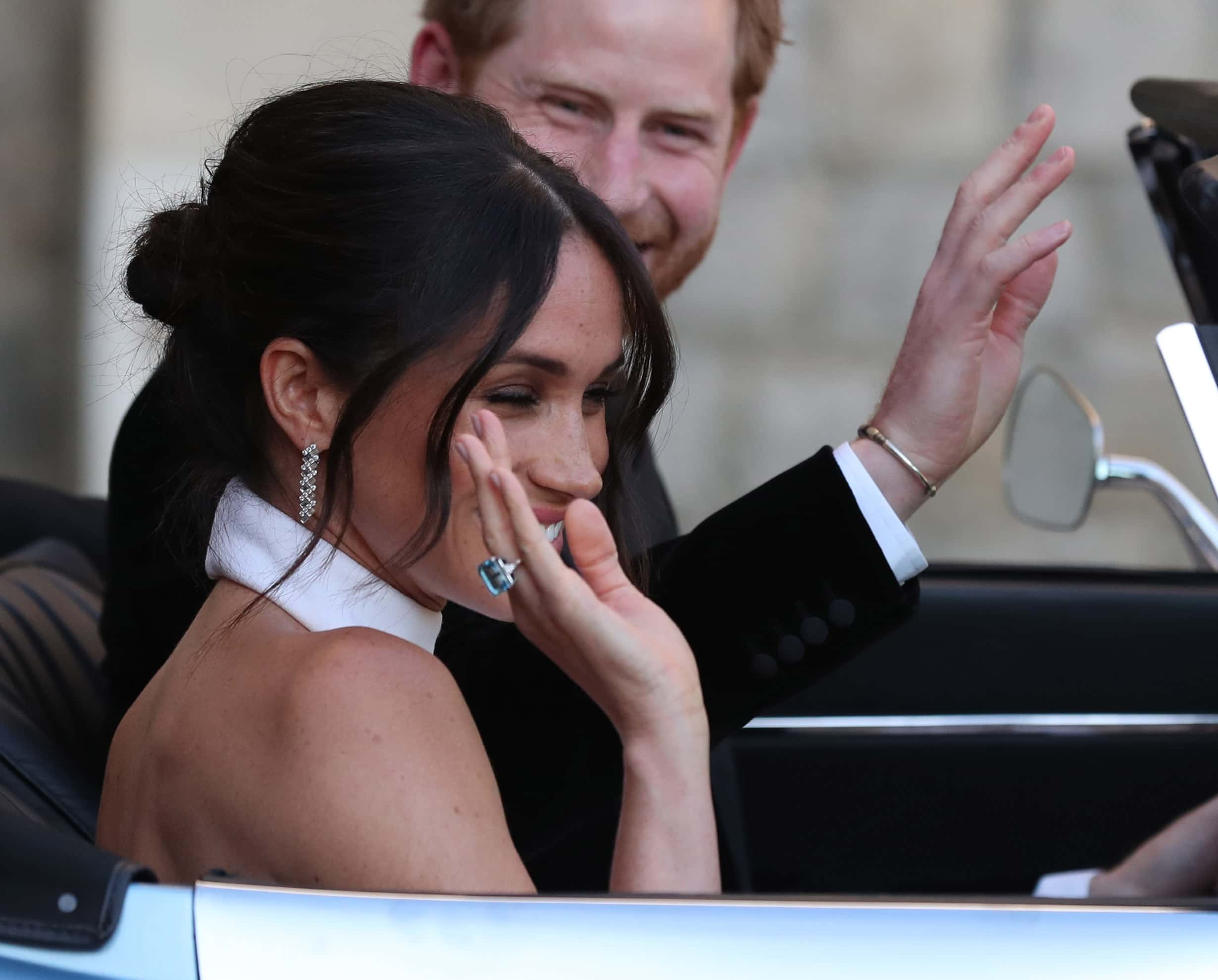 (EDITORS NOTE: Retransmission of #960192808 with alternate crop.) Duchess of Sussex and Prince Harry, Duke of Sussex wave as they leave Windsor Castle after their wedding to attend an evening reception at Frogmore House, hosted by the Prince of Wales on May 19, 2018 in Windsor, England. The bride is wearing an emerald-cut aquamarine ring which belonged to Diana, Princess of Wales.