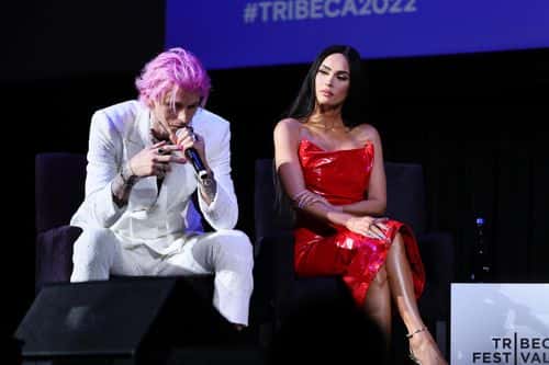 Machine Gun Kelly and Megan Fox speak onstage at the