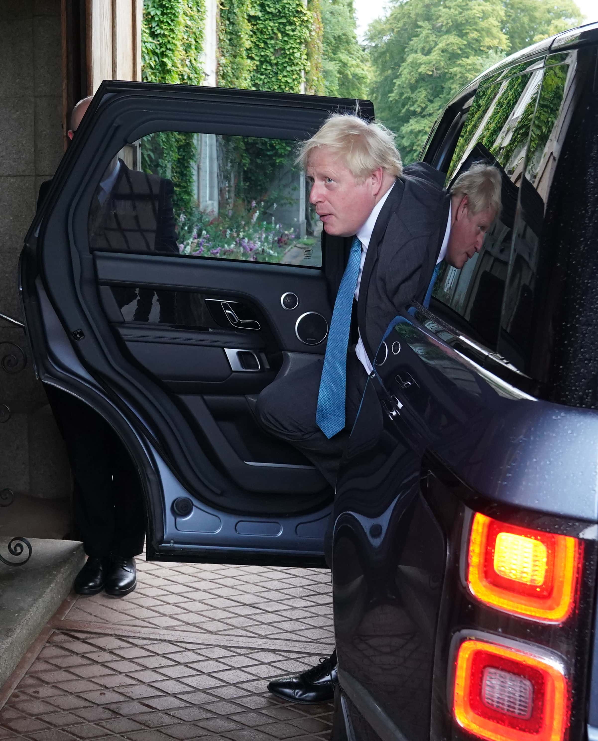 Outgoing Prime Minister Boris Johnson arrives ahead of his audience with Queen Elizabeth II to formally resign as Prime Minister at Balmoral Castle on September 6, 2022 in Aberdeen, Scotland. The Queen broke with the tradition of meeting the new prime minister and Buckingham Palace, after needing to remain at Balmoral Castle due to mobility issues.