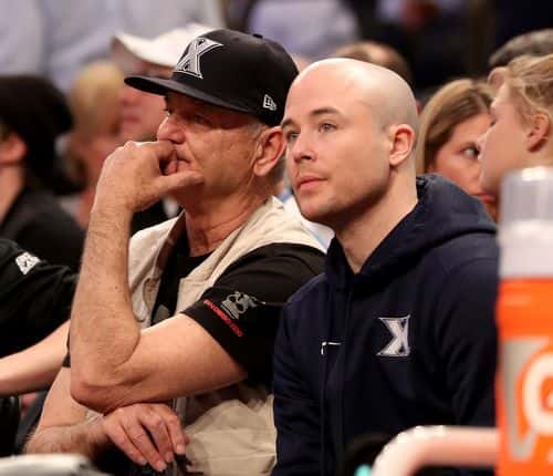 Bill Murray sits with his son, Xavier Musketeers assistant coach Luke Murray as they watch the game between the Creighton Bluejays and the Seton Hall Pirates during the quarterfinals of the Big East Basketball Tournament on March 10, 2016 at Madison Square Garden in New York City.