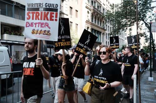 Members of the actors SAG-AFTRA union walk a picket line with screenwriters outside of Netflix's New York office on Day 2 of the actors' strike on July 14, 2023 in New York City. Members of SAG-AFTRA, Hollywood’s largest union which represents actors and other media professionals, joined striking WGA (Writers Guild of America) workers in the first joint walkout against the studios since 1960. The strike could shut down film productions completely with writers in the third month of their strike against the Hollywood studios.