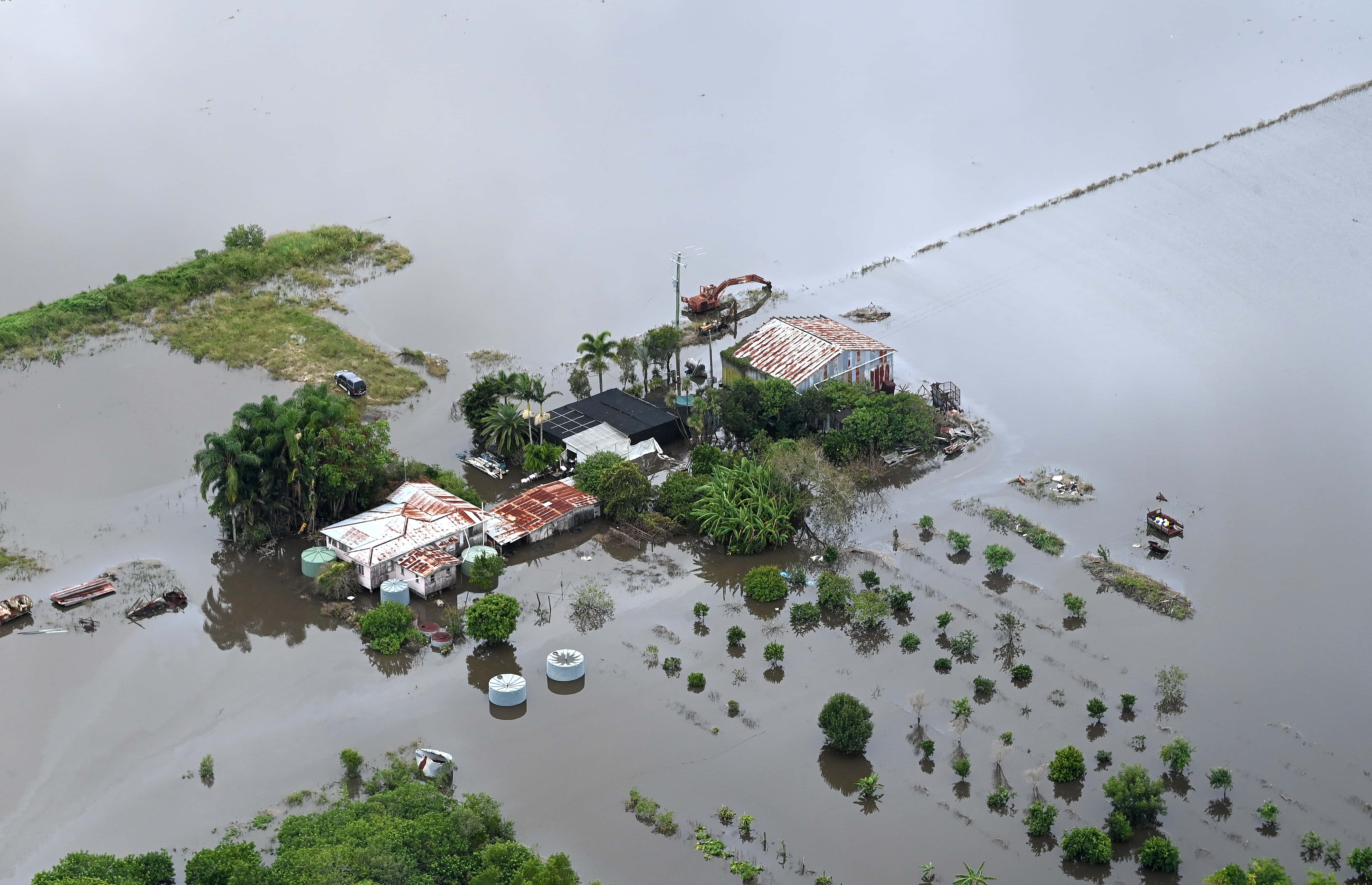 A farm house is surrounded by floodwaters in the town of Bli Bli on February 27, 2022 in Sunshine Coast, Australia. Parts of South-East Queensland are experiencing the worst flooding in over a decade, with several towns under evacuation orders and the death toll reaching five.