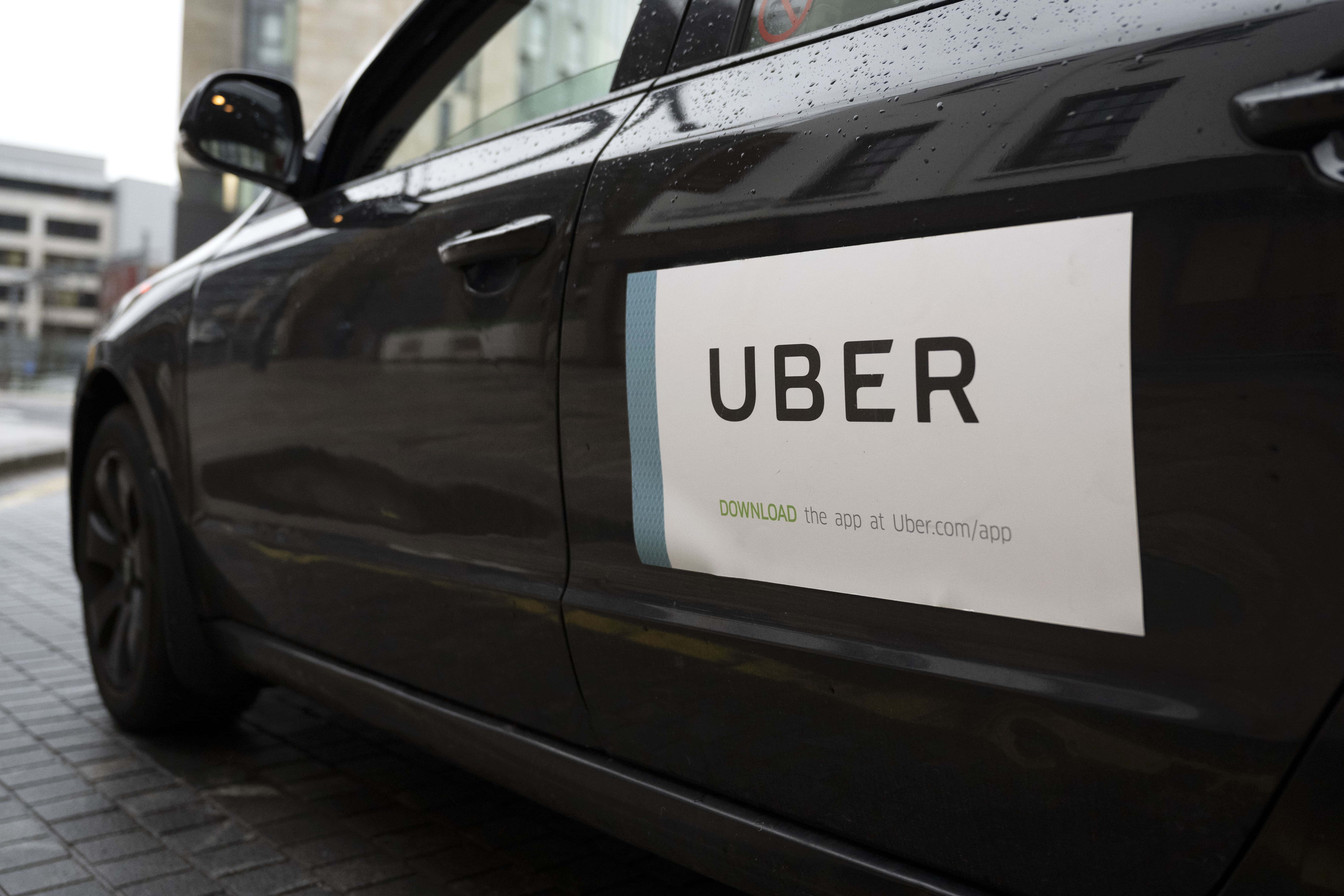 A close-up of an Uber sticker on the side of a car on February 19, 2021 in Cardiff, Wales. Uber drivers in the UK have won a six-year battle to be recognised as workers by the taxi firm and not self-employed. This could mean they are now entitled to the minimum wage and paid holiday.