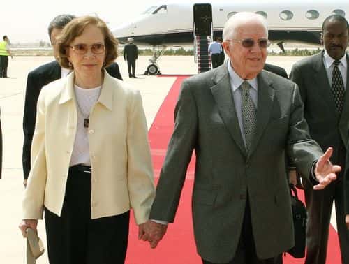 Former US President Jimmy Carter accompanied with his wife Rosalynn arrives at Queen Alia International airport on April 20, 2008 in Amman, Jordan. Carter in the Middle East tour, has met exiled Hamas leader Khaled Meshaal in the Syrian capital despite strong opposition from Israel and the White House. (Photo by Jamal Nasrallah-pool/Getty Images)
