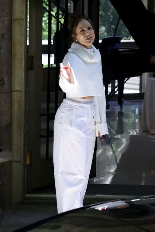 Jennifer Lopez looked casual yet stylish as she wore a large white sweater with ribbed detailing while going house-hunting in LA (Backgrid)