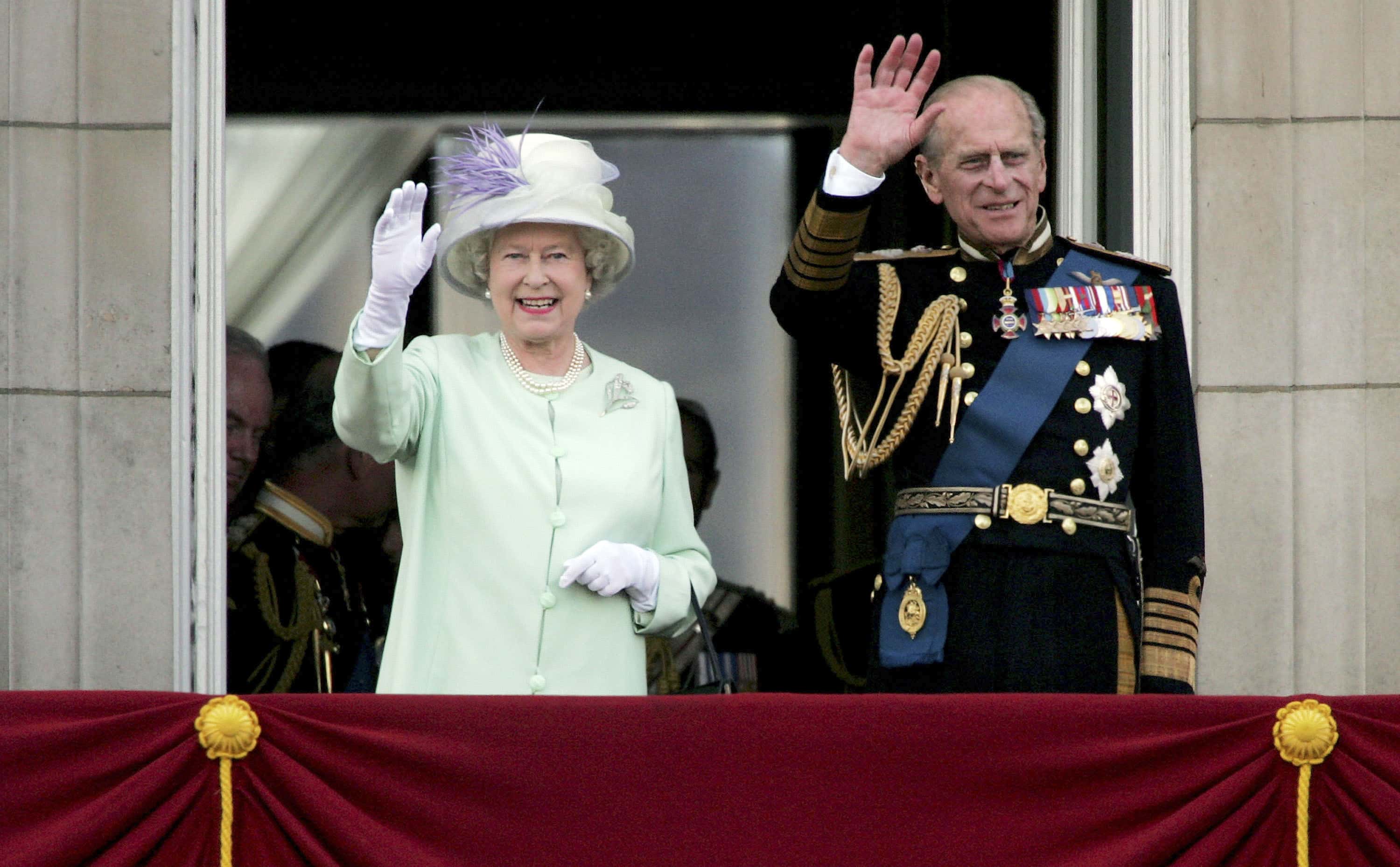 HM Queen Elizabeth II, The Queen, and Prince Philip, Duke of Edinburgh, watch the flypast over The Mall of British and US World War II aircraft from the Buckingham Palace balcony on National Commemoration Day July 10, 2005 in London.  Poppies were dropped from the Lancaster Bomber of the Battle Of Britain Memorial Flight as part of the flypast.