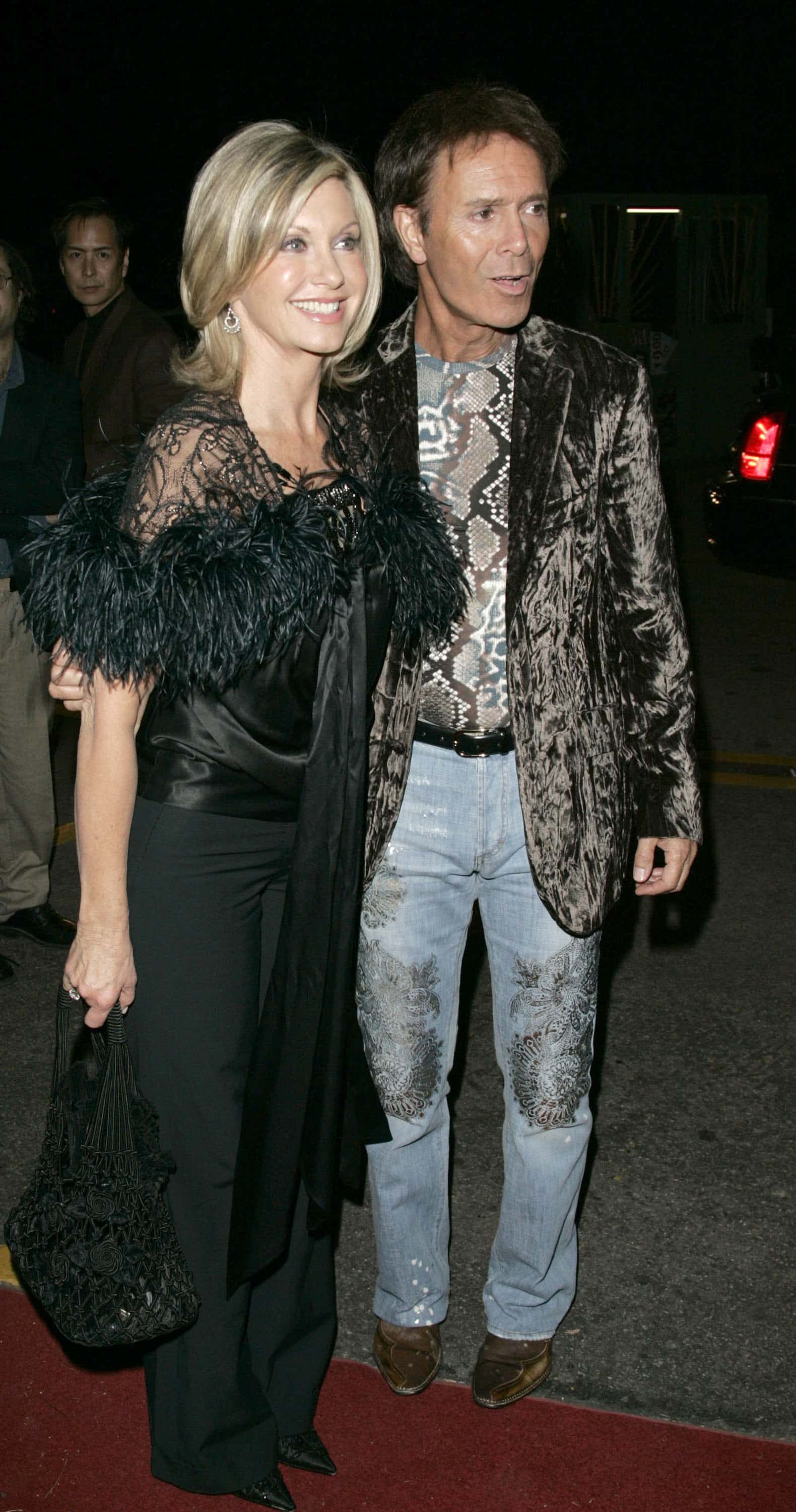 Singer Olivia Newton-John (L) and actor Cliff Richard (R) arrive at the Dionne Warwick: 45th Anniversary Spectacular after party at the Hollywood Palladium on January 26, 2006 in Los Angeles, California.