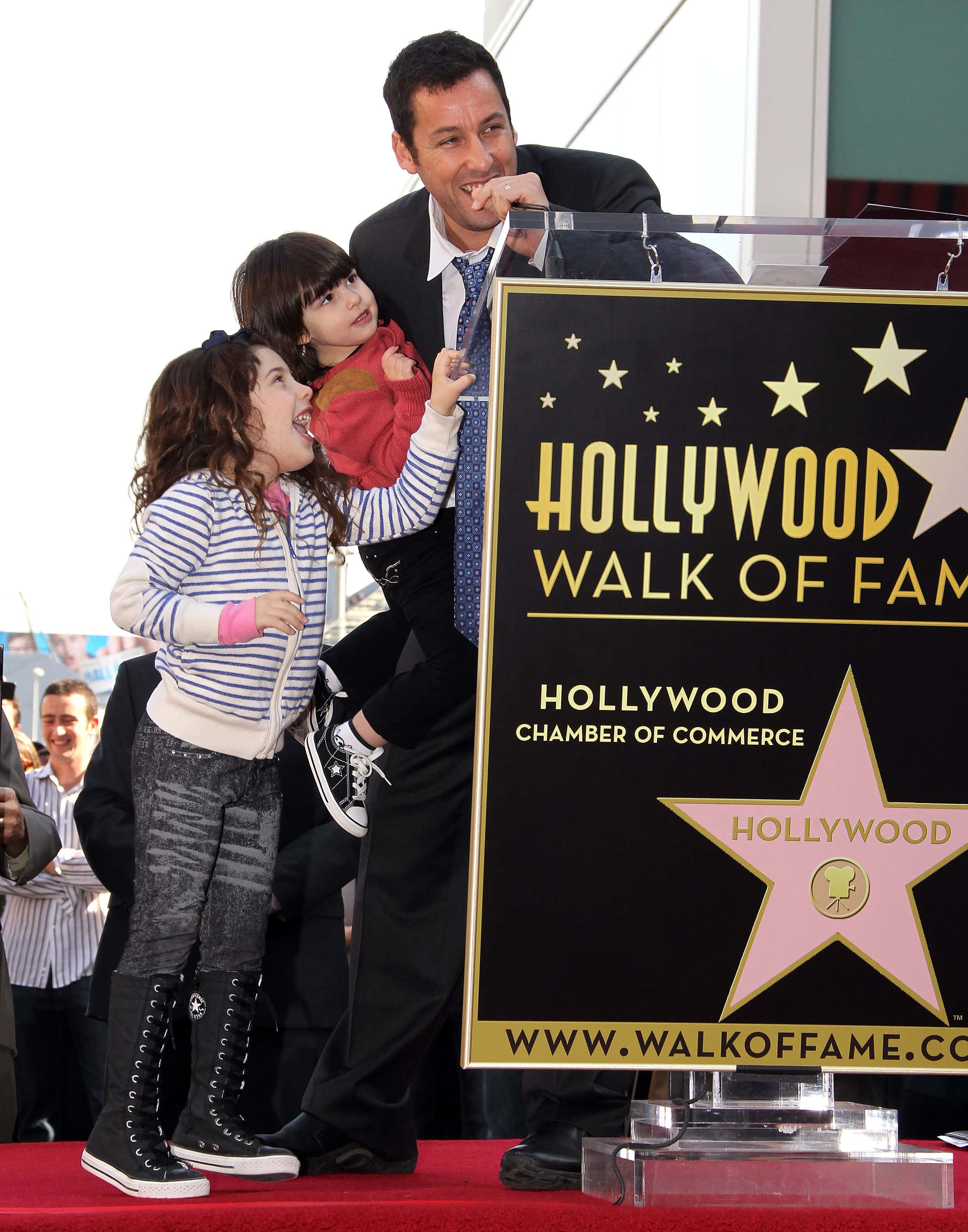 Actor Adam Sandler and his children pose for photographers during the installation ceremony for his star on the Hollywood Walk of Fame on February 1, 2011 in Hollywood, California. (Photo by Frederick M. Brown/Getty Images)