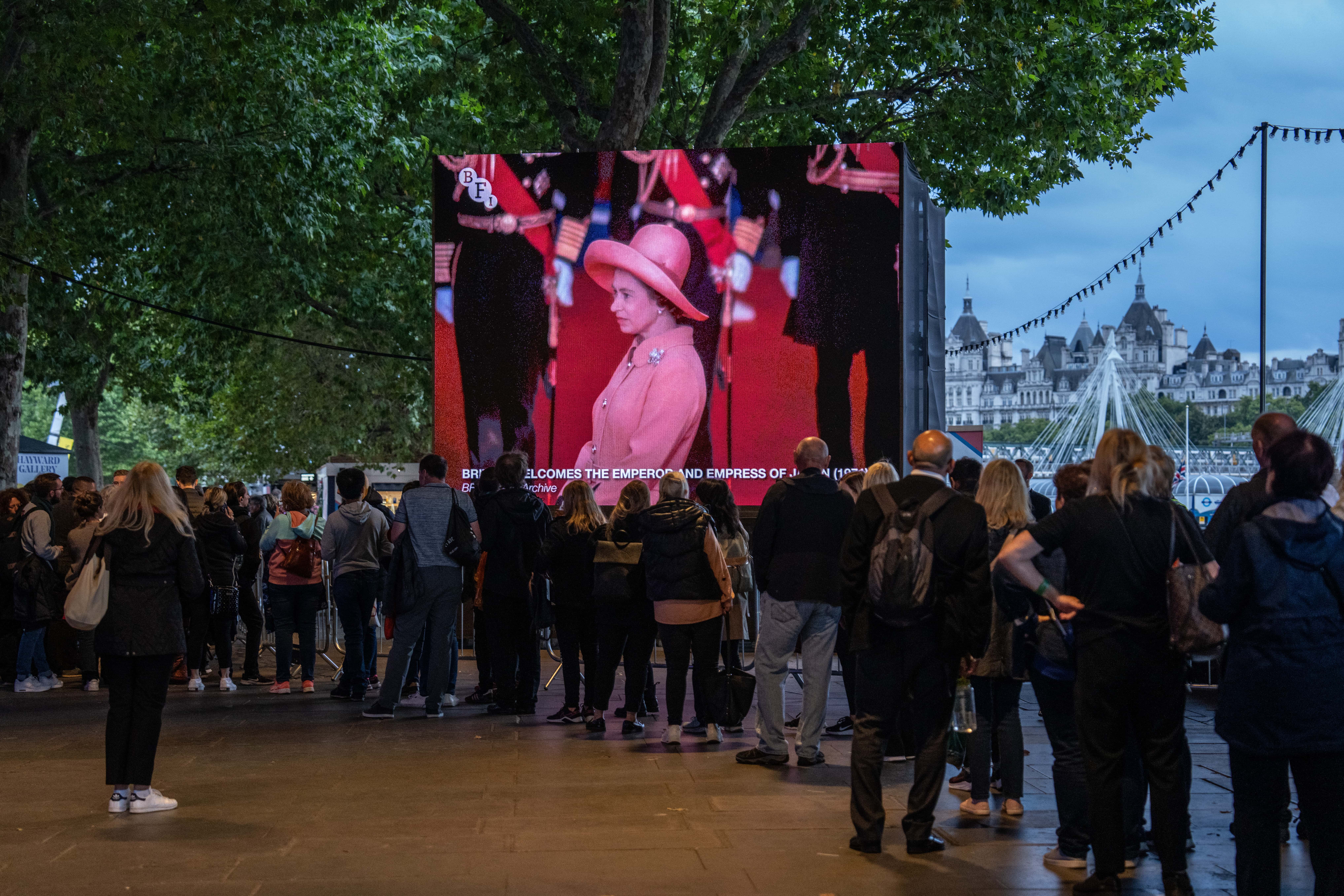 Archive footage of the 1971 state visit to the UK by Emperor Hirohito of Japan is shown as people queue to visit the Palace of Westminster where the body of Queen Elizabeth II is lying in state on September 15, 2022 in London, United Kingdom. (Photo by Carl Court/Getty Images)