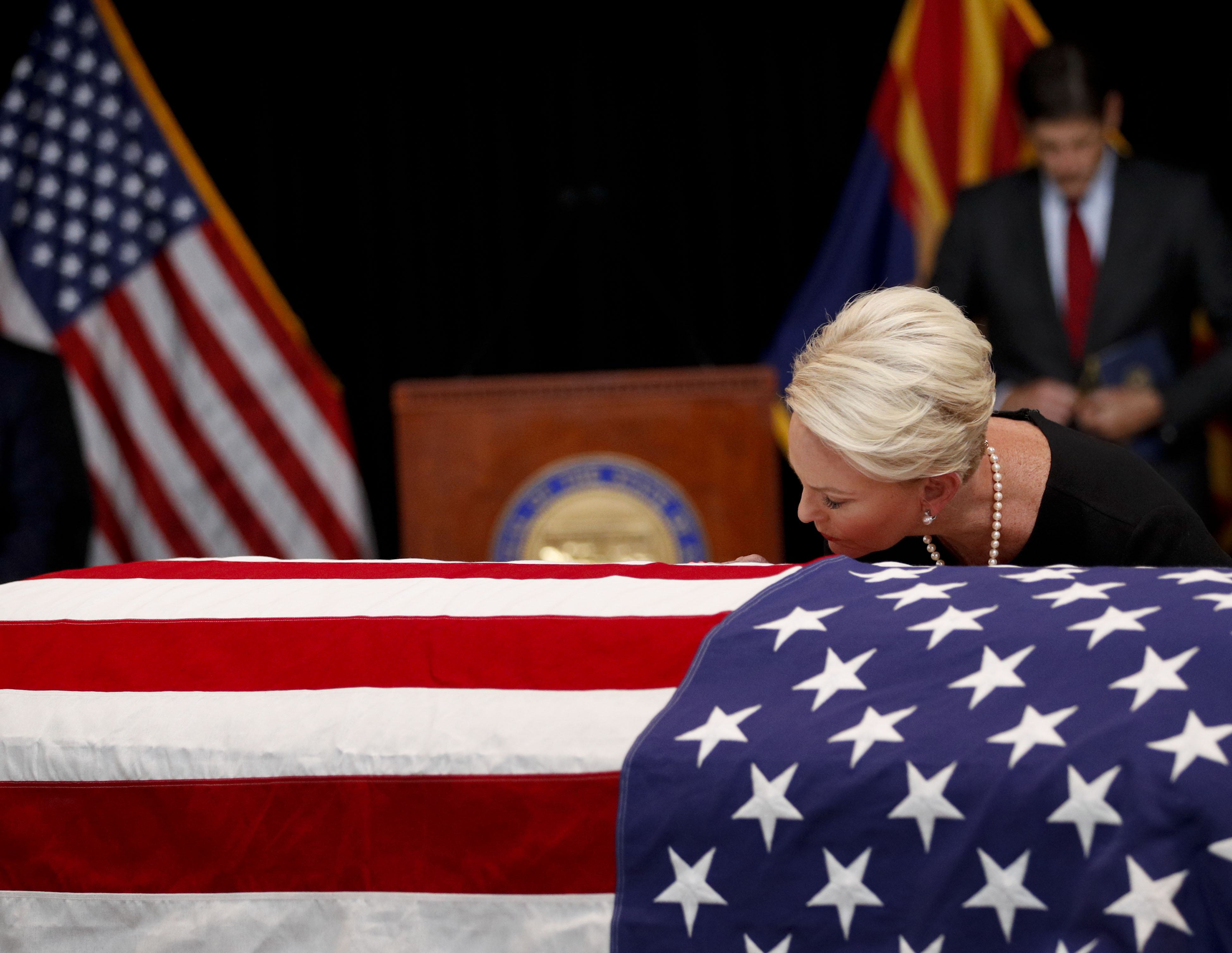 Cindy McCain, wife of Sen. John McCain, R-Ariz. touches the casket during a memorial service at the Arizona Capitol on August 29, 2018 in Phoenix, Arizona. Sen. McCain, a decorated war hero, died August 25 at the age of 81 after a long battle with Glioblastoma, a form of brain cancer.