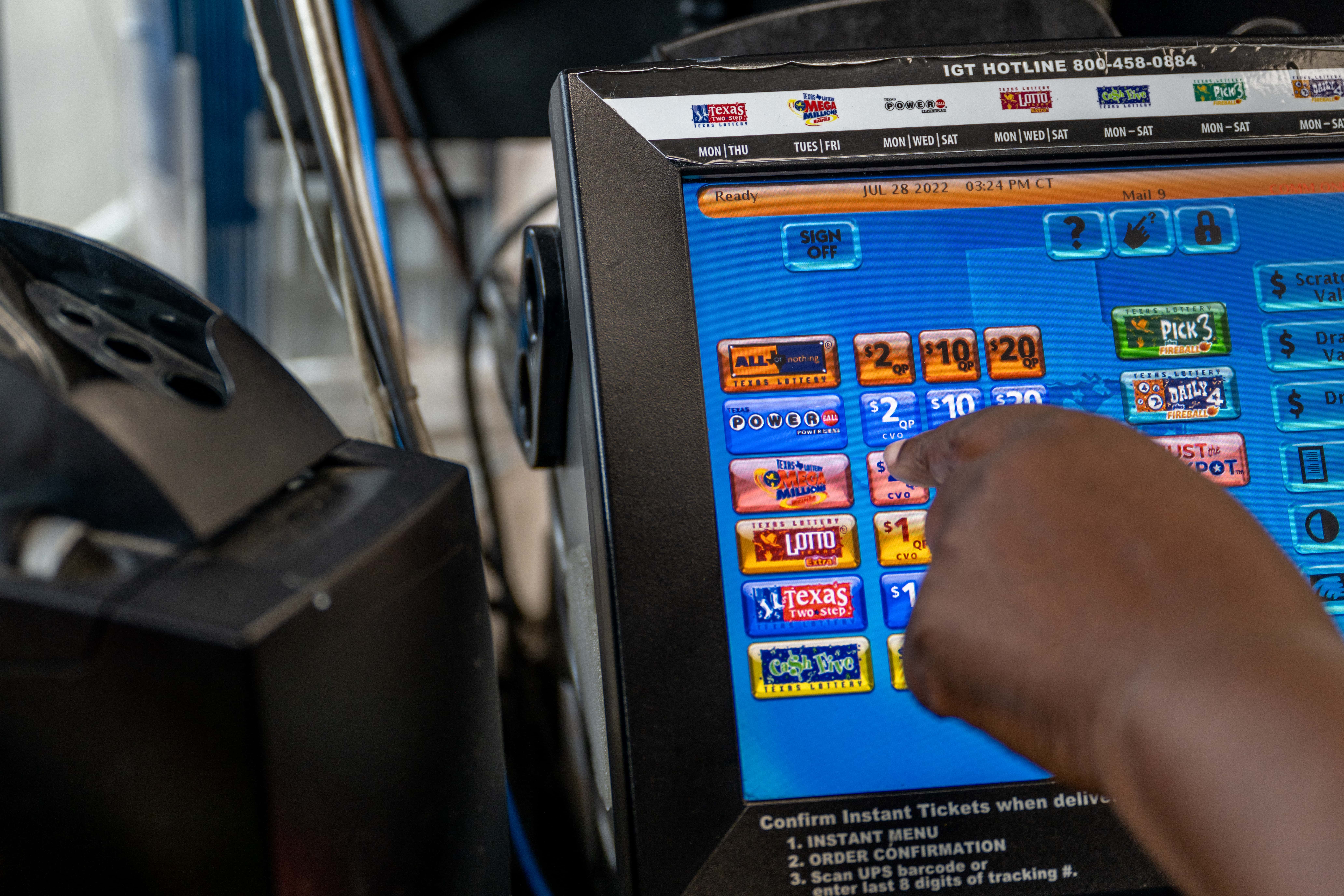 A Chevron employee rings up a Mega Millions lottery ticket on July 28, 2022 in Houston City. The lottery jackpot has increased to $1 Billion after not being matched Tuesday night.