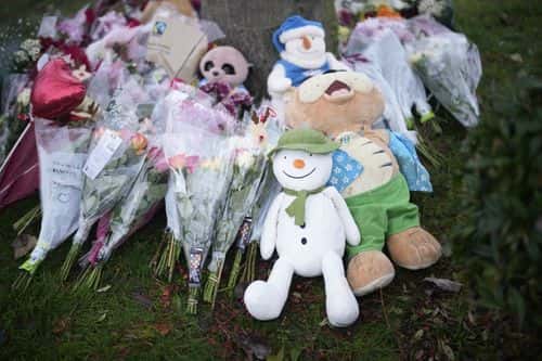 Flowers are left near the scene after three young boys died when a number of children fell through ice on a lake, on December 12, 2022 at Babbs Mill Park in Solihull, England. Three boys aged eight, 10 and 11 have died after falling through an icy lake last night. The search continued for more potential victims, following reports more children were present on the ice at the time of the incident.