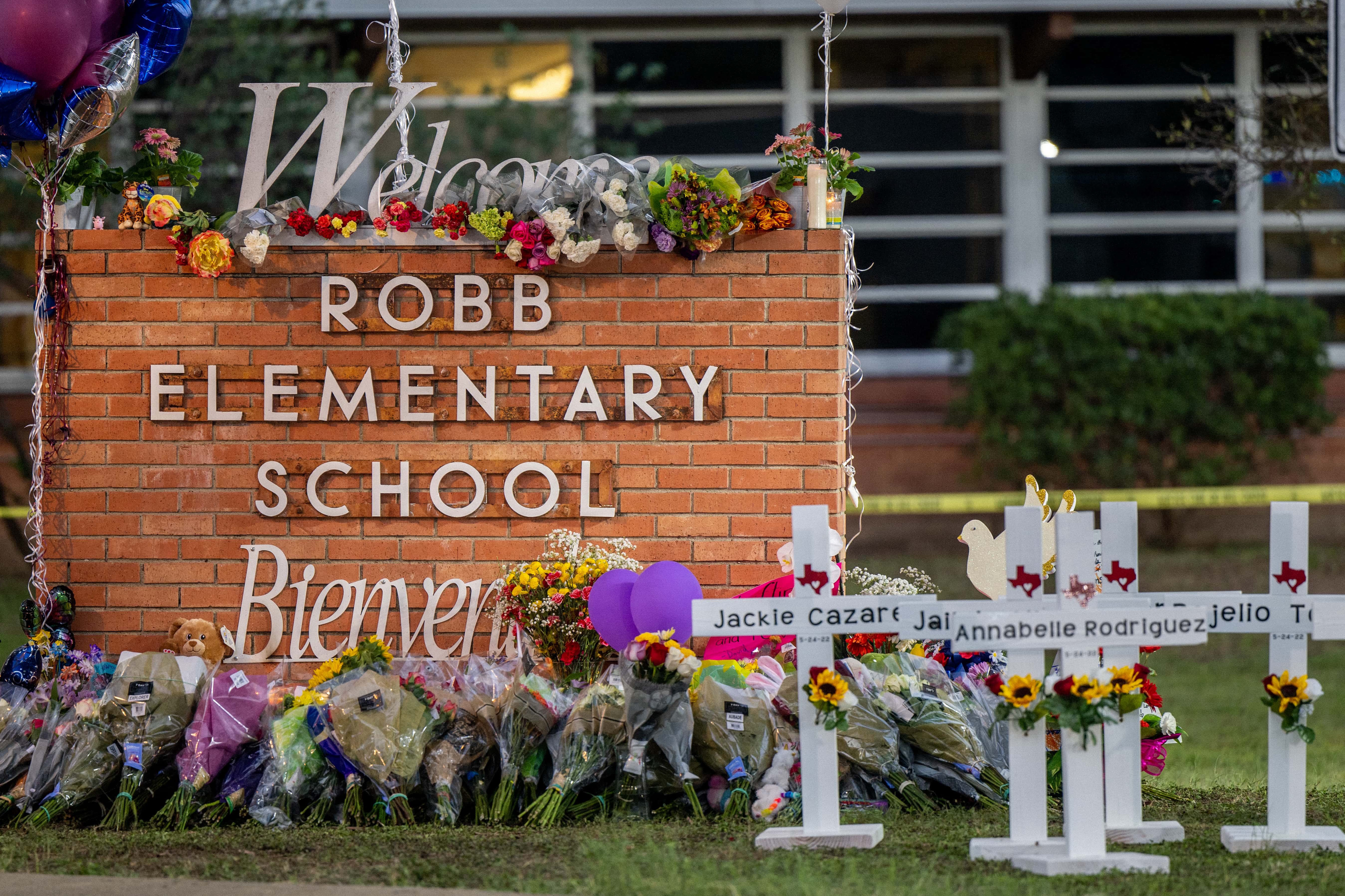 A memorial is seen surrounding the Robb Elementary School sign following the mass shooting at Robb Elementary School on May 26, 2022 in Uvalde, Texas. According to reports, 19 students and 2 adults were killed, with the gunman fatally shot by law enforcement. (Photo by Brandon Bell/Getty Images)