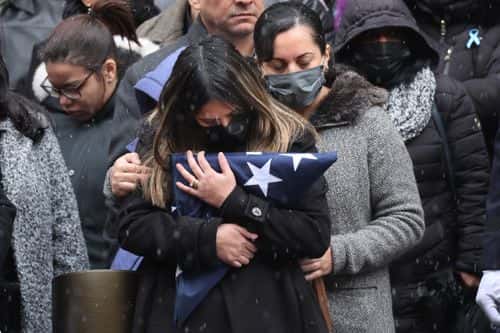 Dominique Rivera, the wife of fallen NYPD Officer Jason Rivera, holds a flag from his casket during his funeral at St. Patrick's Cathedral on January 28, 2022 in New York City. The 22-year-old NYPD officer was shot and killed on January 21 in Harlem while responding to a domestic disturbance call. Rivera's partner, Officer Wilbert Mora, also died from injuries suffered in the shooting.