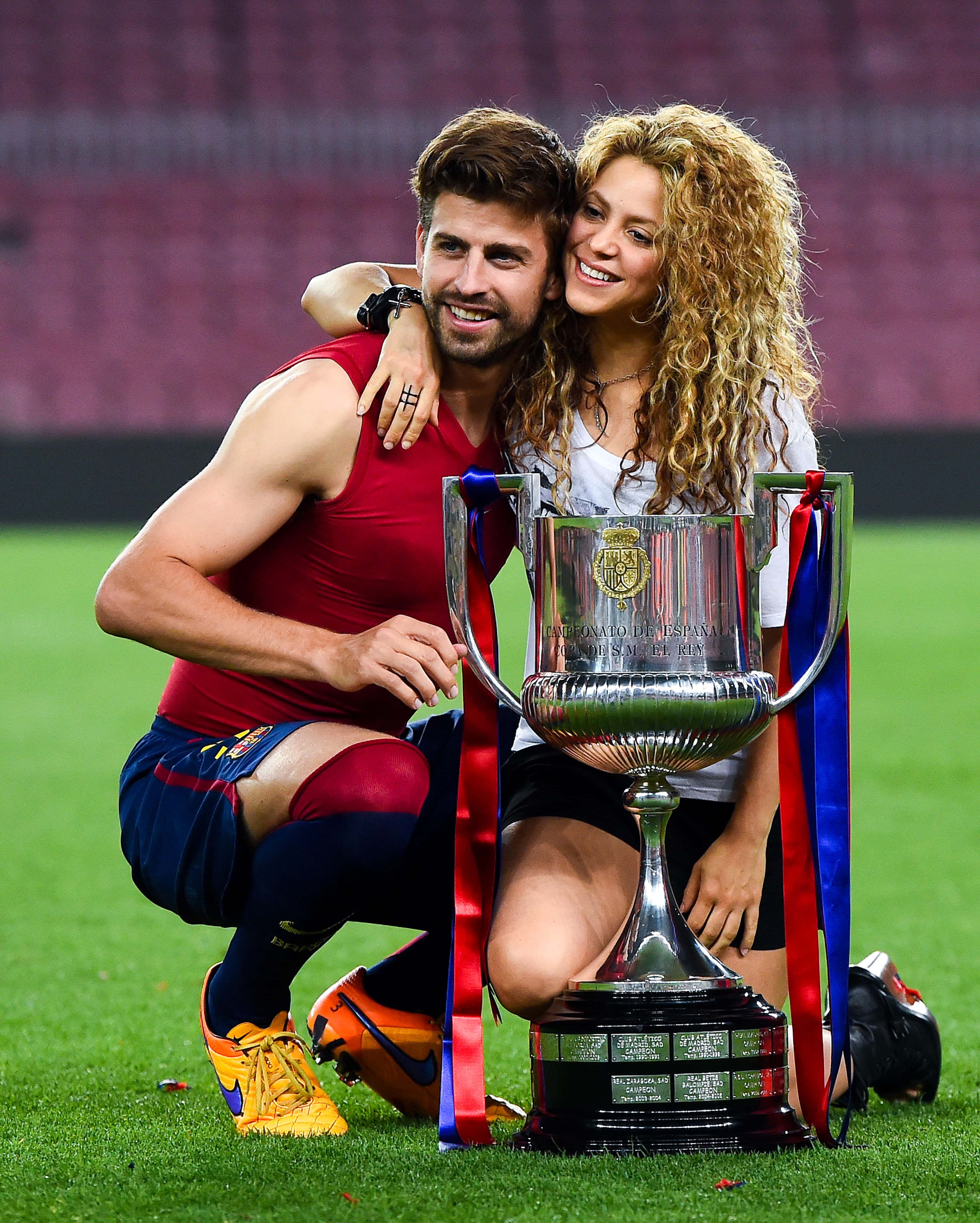 BARCELONA, SPAIN - MAY 30: Gerard Pique of FC Barcelona and Shakira pose with the trophy after FC Ba