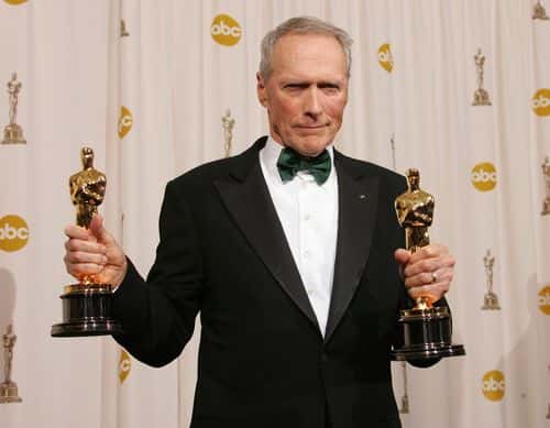 Director Clint Eastwood poses with his Oscar award for Best Director in 