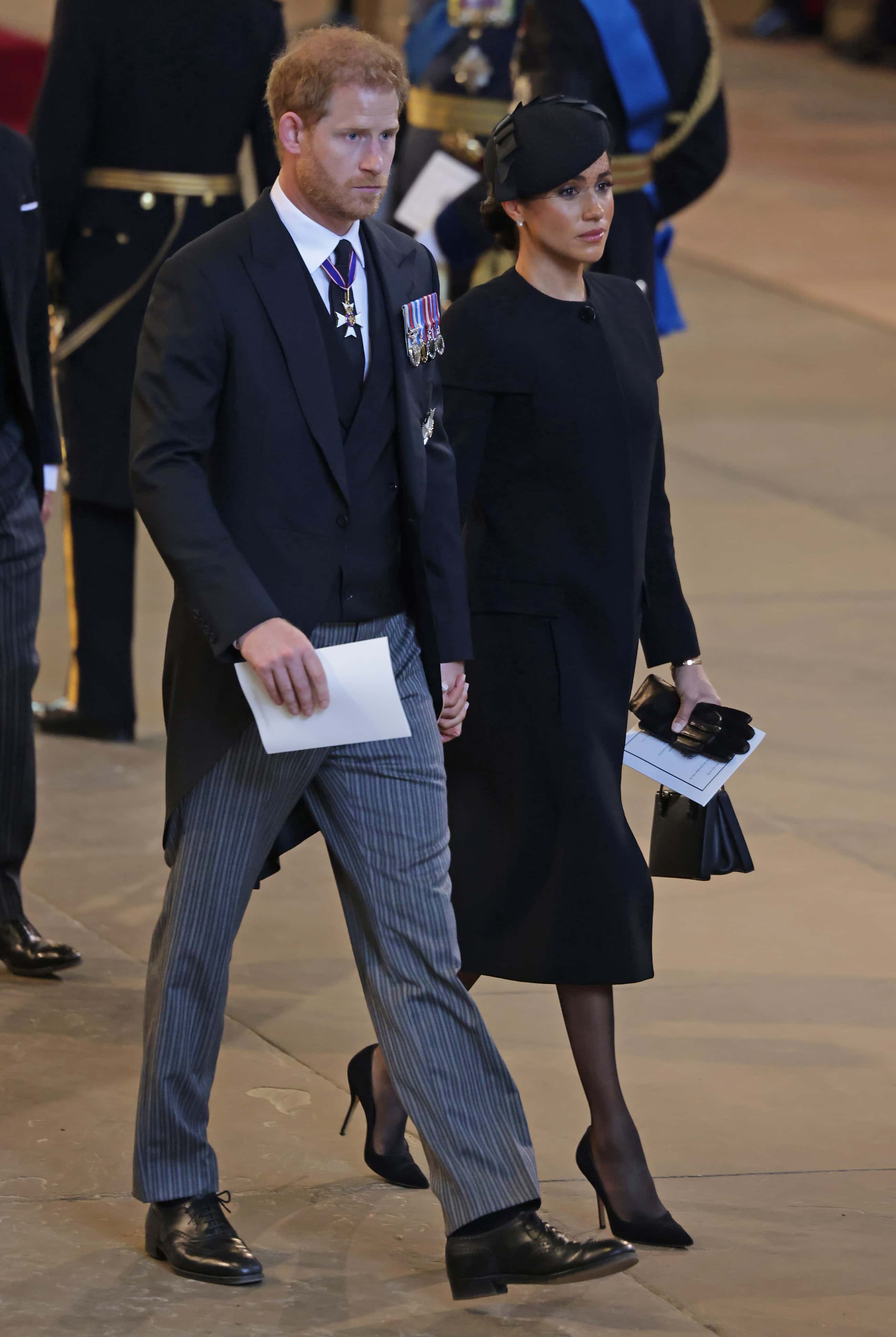 Prince Harry, Duke of Sussex and Meghan, Duchess of Sussex leave Westminster Hall on September 14, 2022 in London, United Kingdom. Queen Elizabeth II's coffin is taken in procession on a Gun Carriage of The King's Troop Royal Horse Artillery from Buckingham Palace to Westminster Hall where she will lay in state until the early morning of her funeral. Queen Elizabeth II died at Balmoral Castle in Scotland on September 8, 2022, and is succeeded by her eldest son, King Charles III.
