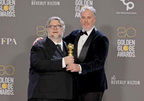 (L-R) Guillermo del Toro and Mark Gustafson pose with the award for Best Animated Feature for
